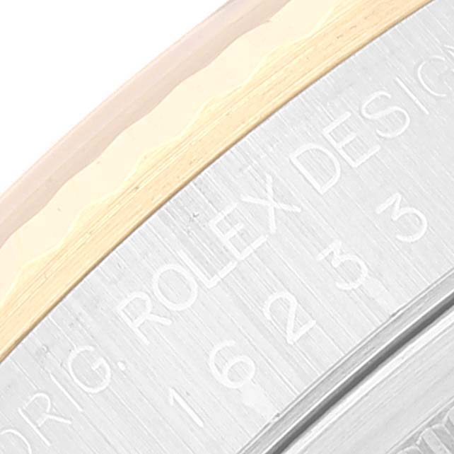 The image shows a close-up of the casing, including the etched text and part of the bezel of the Rolex Datejust 16233 Men's Steel and Gold (two tone) Black Dial 16233 Men's Steel and Gold (two tone) Black Dial model.