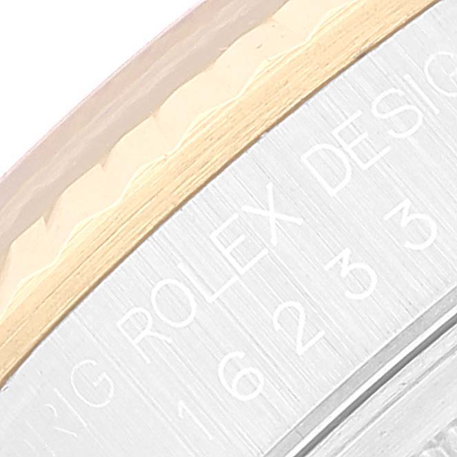 The image shows a close-up of the bezel and engraved text on the side of a Rolex Datejust 16233 Men's Steel and Gold (two tone) Black Dial 16233 Men's Steel and Gold (two tone) Black Dial watch.