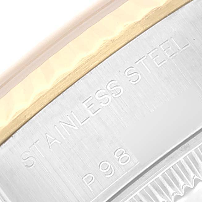 This close-up of a Rolex Datejust 79173 Women's Steel and Gold (two tone) Champagne Dial 79173 Women's Steel and Gold (two tone) Champagne Dial watch shows the "STAINLESS STEEL" inscription and part of the watch's bezel.