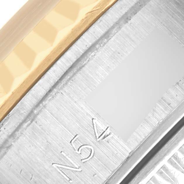 The image shows a close-up of the Rolex Datejust 69173 Women's Steel and Gold (two tone) Champagne Dial 69173 Women's Steel and Gold (two tone) Champagne Dial's bezel and engraved serial on the watch case.