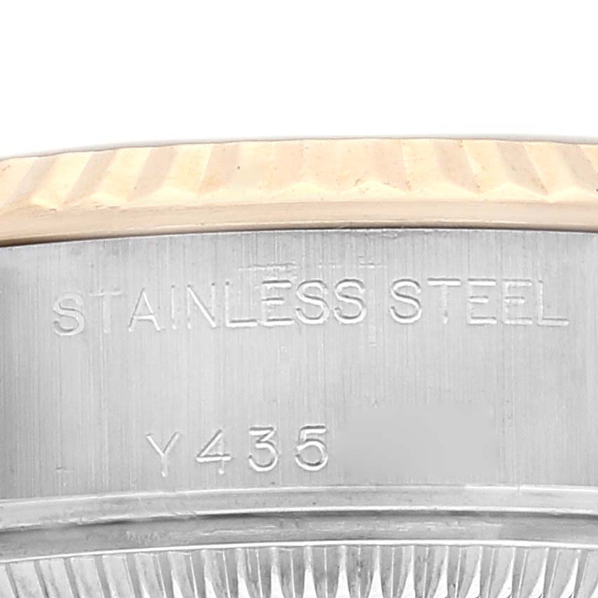 This close-up shows the side of the Rolex Datejust 79173 Women's Steel and Gold (two tone) Champagne Dial 79173 Women's Steel and Gold (two tone) Champagne Dial watch, highlighting the stainless steel band and part of the engraved serial number.