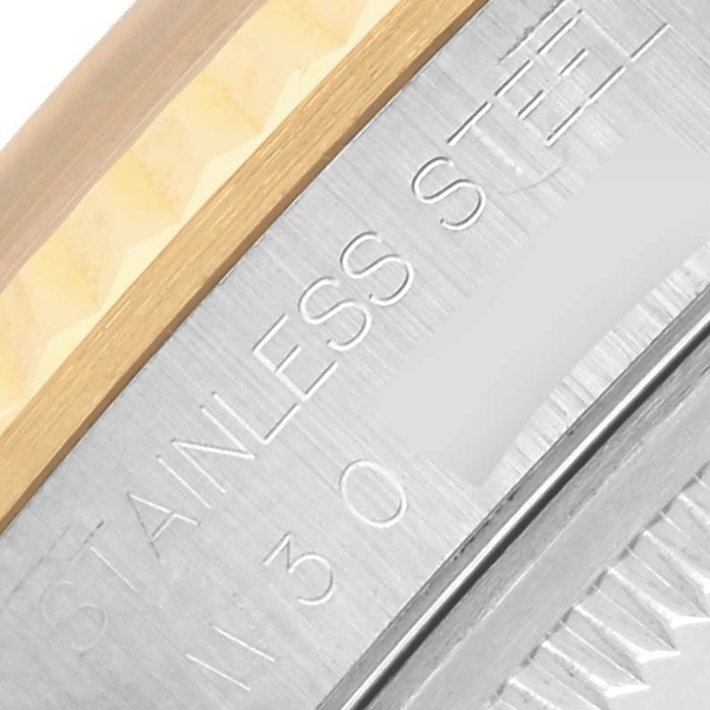 The image shows a close-up of the stainless steel and gold bezel of a Rolex Datejust 16233 Men
s Steel and Gold (two tone) Champagne Dial 16233 Men
s Steel and Gold (two tone) Champagne Dial watch.