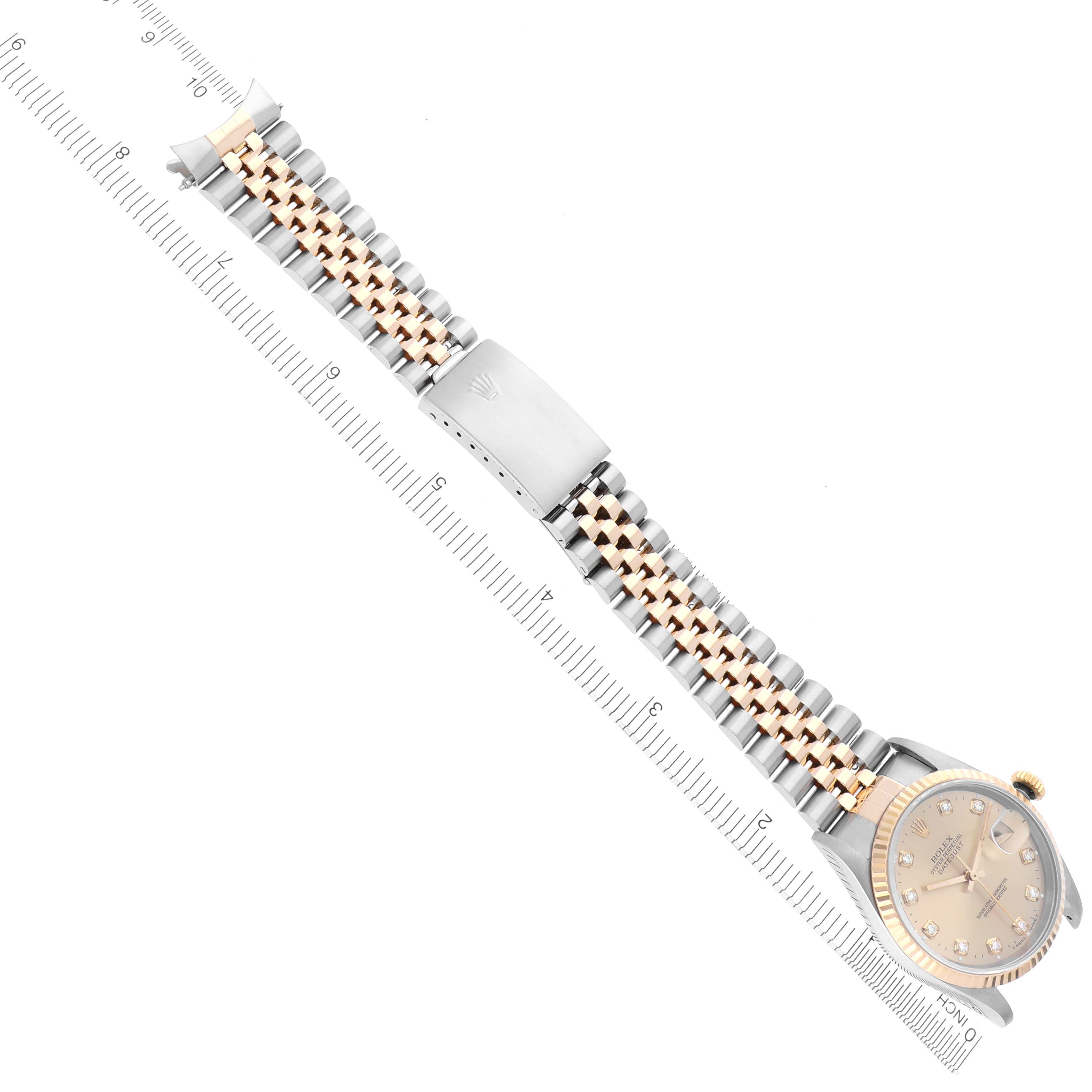 The Rolex Datejust 16233 Men
s Steel and Gold (two tone) Champagne Dial 16233 Men
s Steel and Gold (two tone) Champagne Dial is shown from a top-down angle, displaying the full bracelet, clasp, and watch face with ruler for scale.