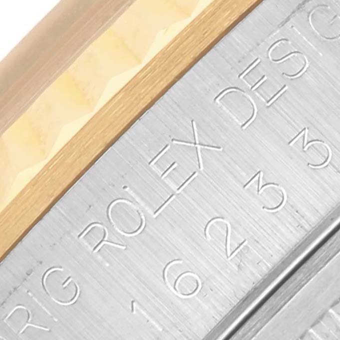 The image shows a close-up of a Rolex Datejust 16233 Men
s Steel and Gold (two tone) Champagne Dial 16233 Men
s Steel and Gold (two tone) Champagne Dial model
s engraving on its bezel.