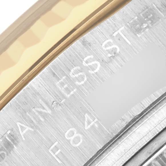 The image shows a close-up of the Rolex Datejust 179173 Women's Steel and Gold (two tone) Mother of Pearl Dial 179173 Women's Steel and Gold (two tone) Mother of Pearl Dial's bezel and edge with engravings on the stainless steel.