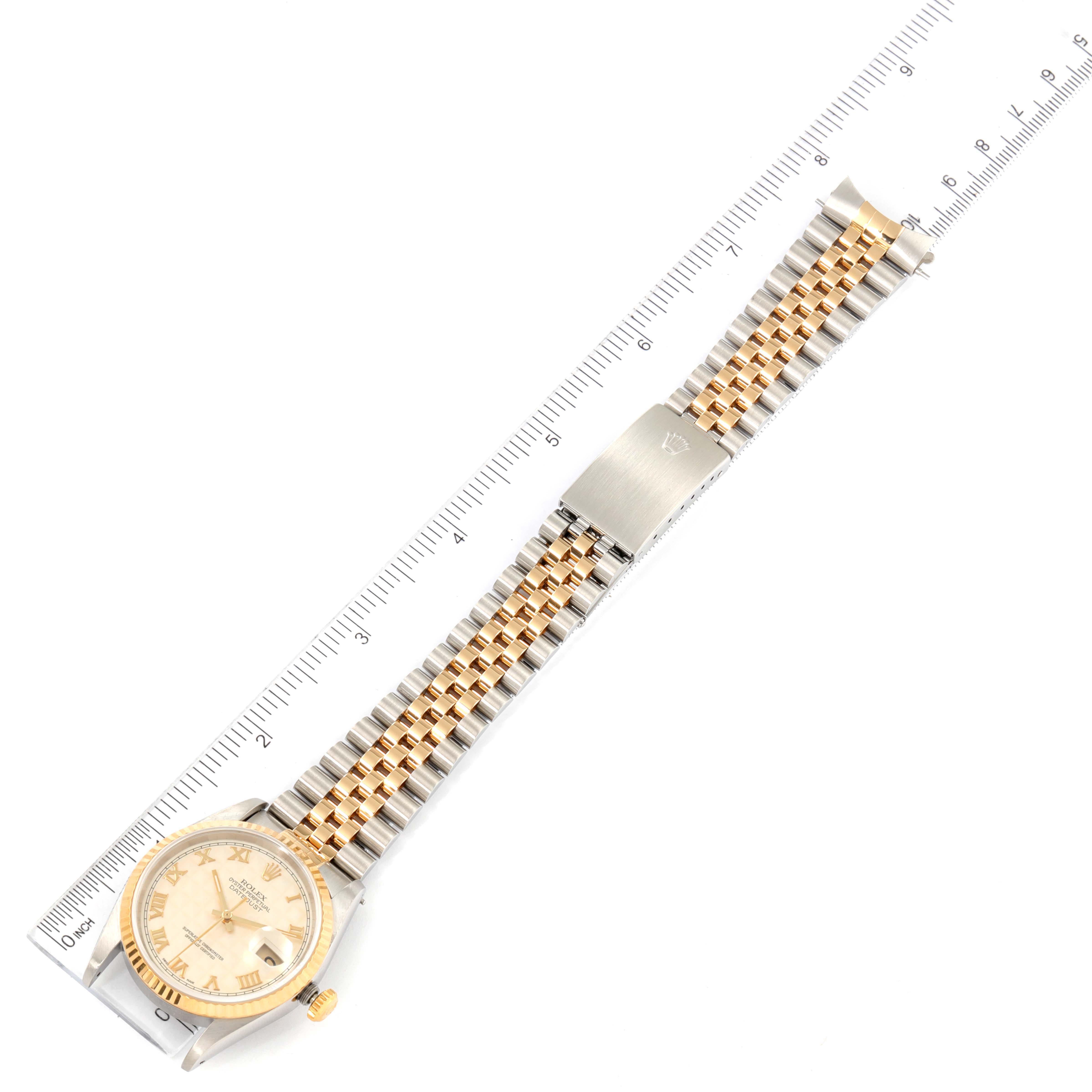 This image shows a Rolex Datejust 16233 Men's Steel and Gold (two tone) Beige Dial 16233 Men's Steel and Gold (two tone) Beige Dial watch laid flat alongside a ruler, displaying its full length and details of its bracelet.