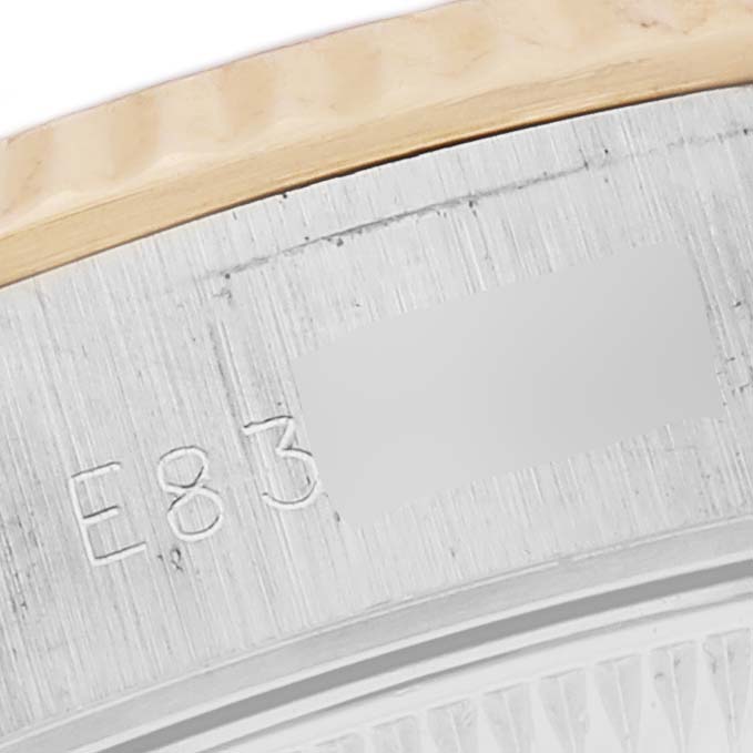 The image shows a close-up of the Rolex Datejust 69173 Women's Steel and Gold (two tone) White Dial 69173 Women's Steel and Gold (two tone) White Dial watch's bezel and engraved detail.