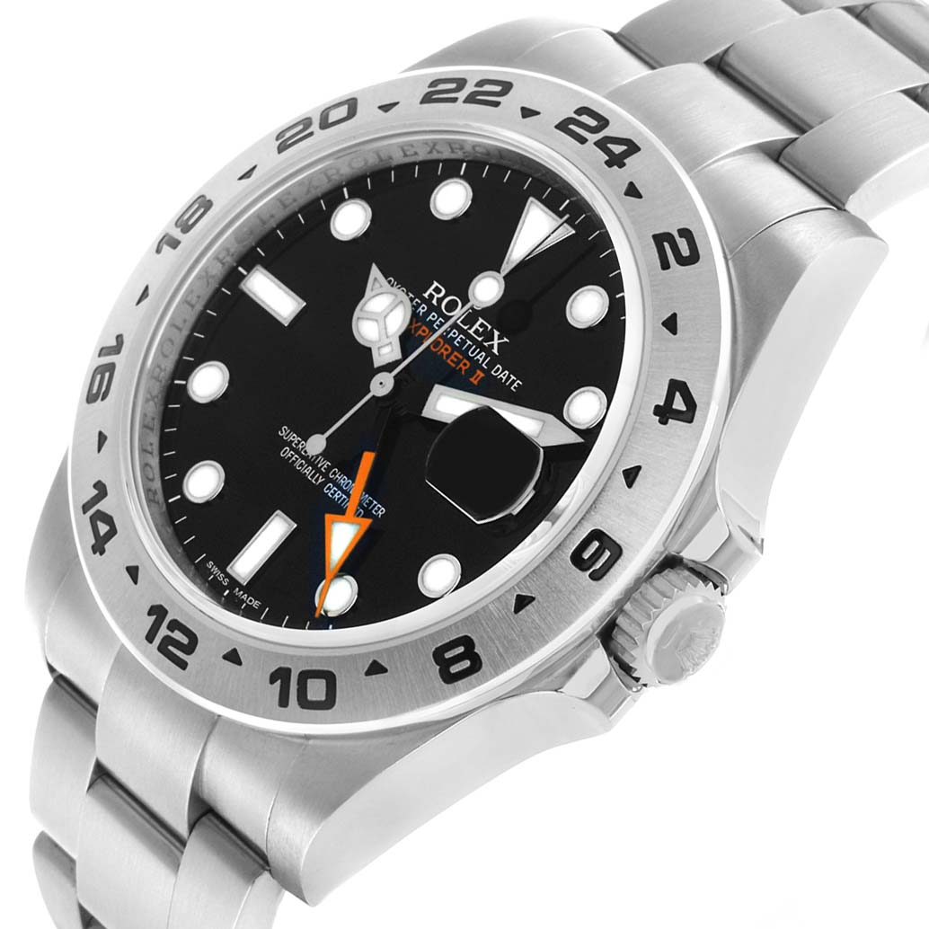 The image shows a Rolex Oyster Perpetual 216570 Men's Stainless Steel Black Dial watch at an oblique angle, displaying the bezel, dial, bracelet, and crown.