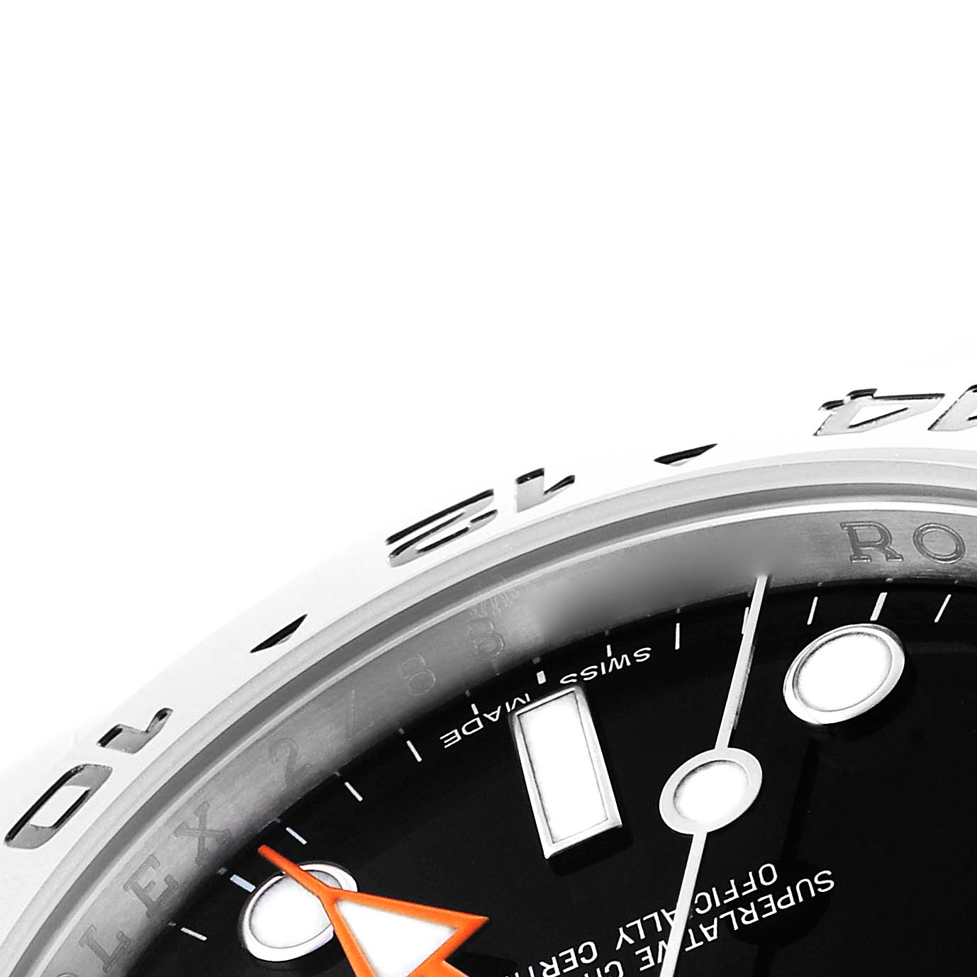 The image shows a close-up angle of the Rolex Oyster Perpetual 216570 Men's Stainless Steel Black Dial's bezel, dial, and part of the orange hand.