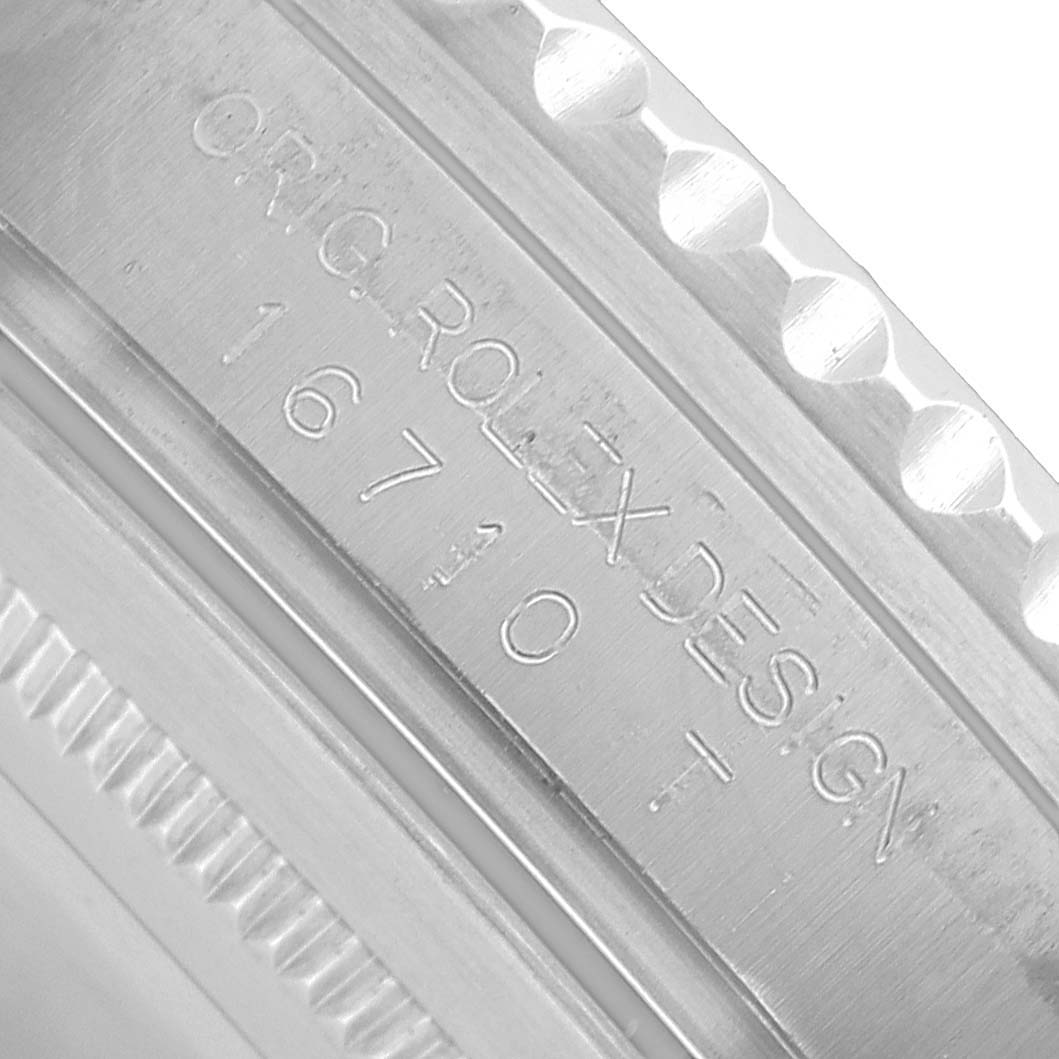 The image shows a close-up of the Rolex GMT-Master 16710 Men's Stainless Steel Black Dial's engraved case edge, highlighting the model number and part of the bezel.