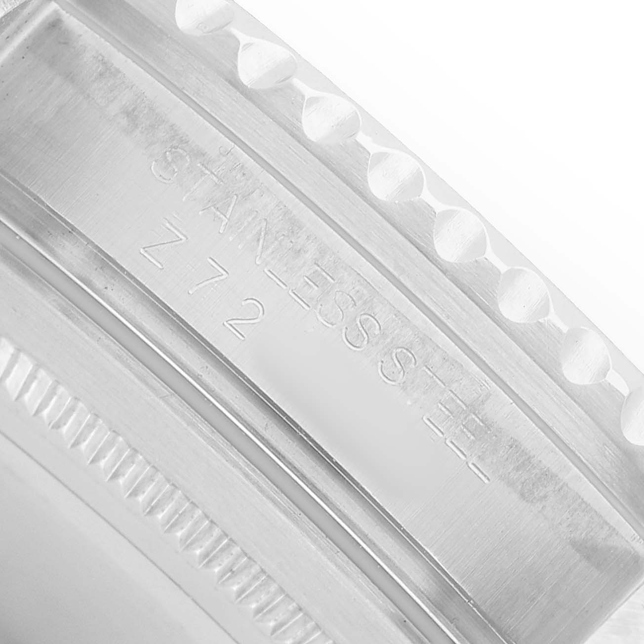 The image shows the edge of a Rolex GMT-Master 16710 Men's Stainless Steel Black Dial watch bezel, highlighting the engravings and notches.
