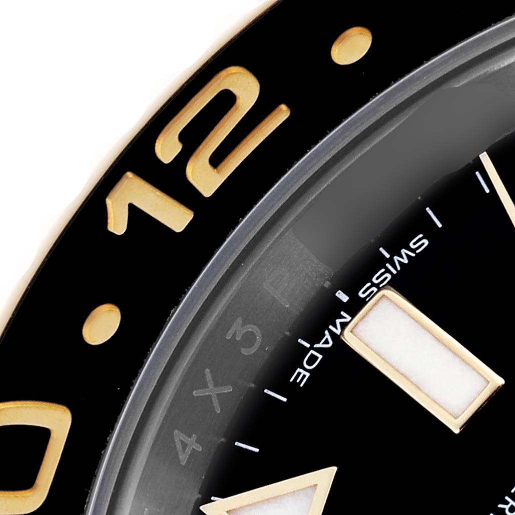 The image shows a close-up of the bezel and part of the dial of a Rolex GMT-Master 116713LN Men's Steel and Gold (two tone) Black Dial 116713LN Men's Steel and Gold (two tone) Black Dial watch, highlighting the 12-hour mark.