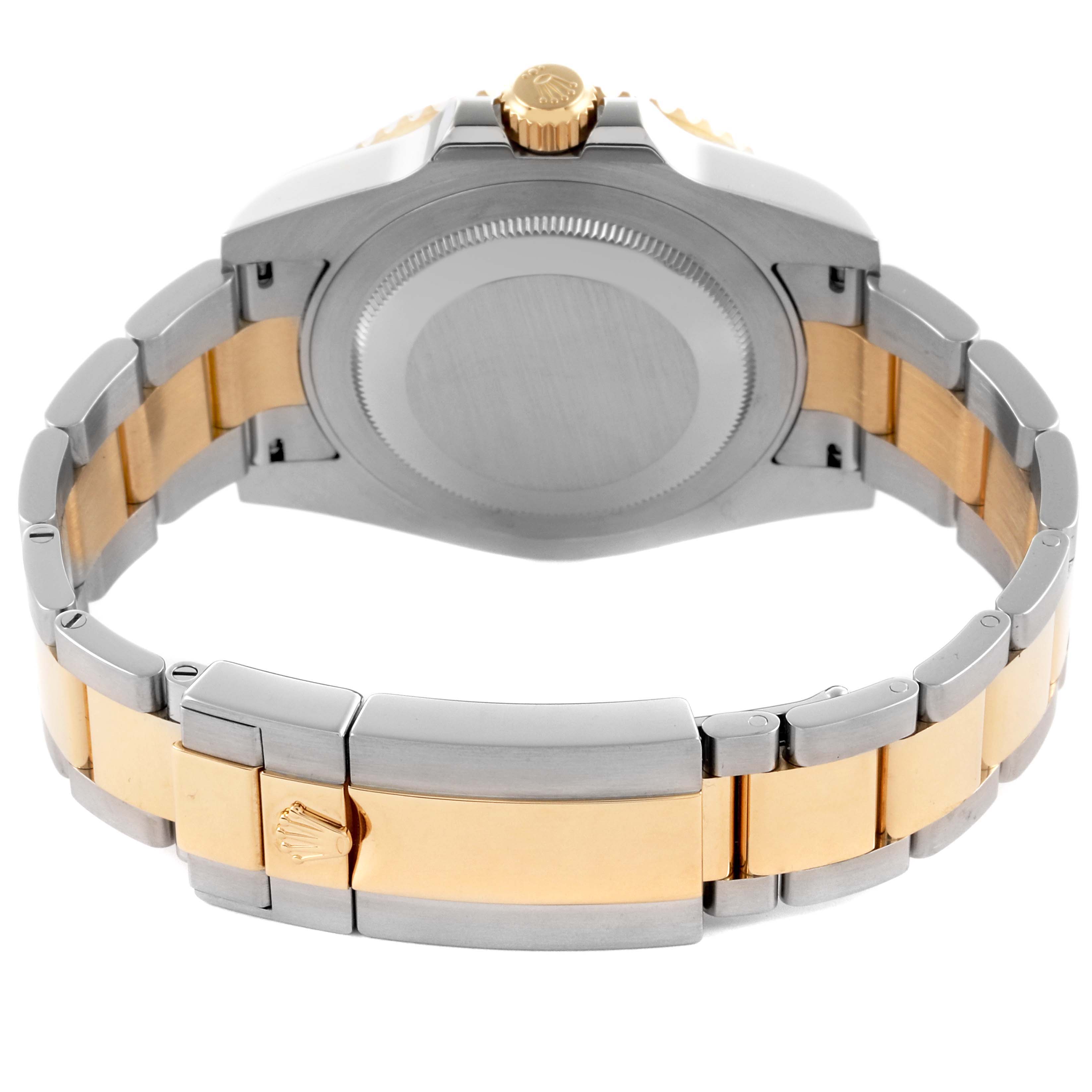 The Rolex GMT-Master 116713LN Men's Steel and Gold (two tone) Black Dial 116713LN Men's Steel and Gold (two tone) Black Dial watch is shown from the back, highlighting its case back and the two-tone bracelet.