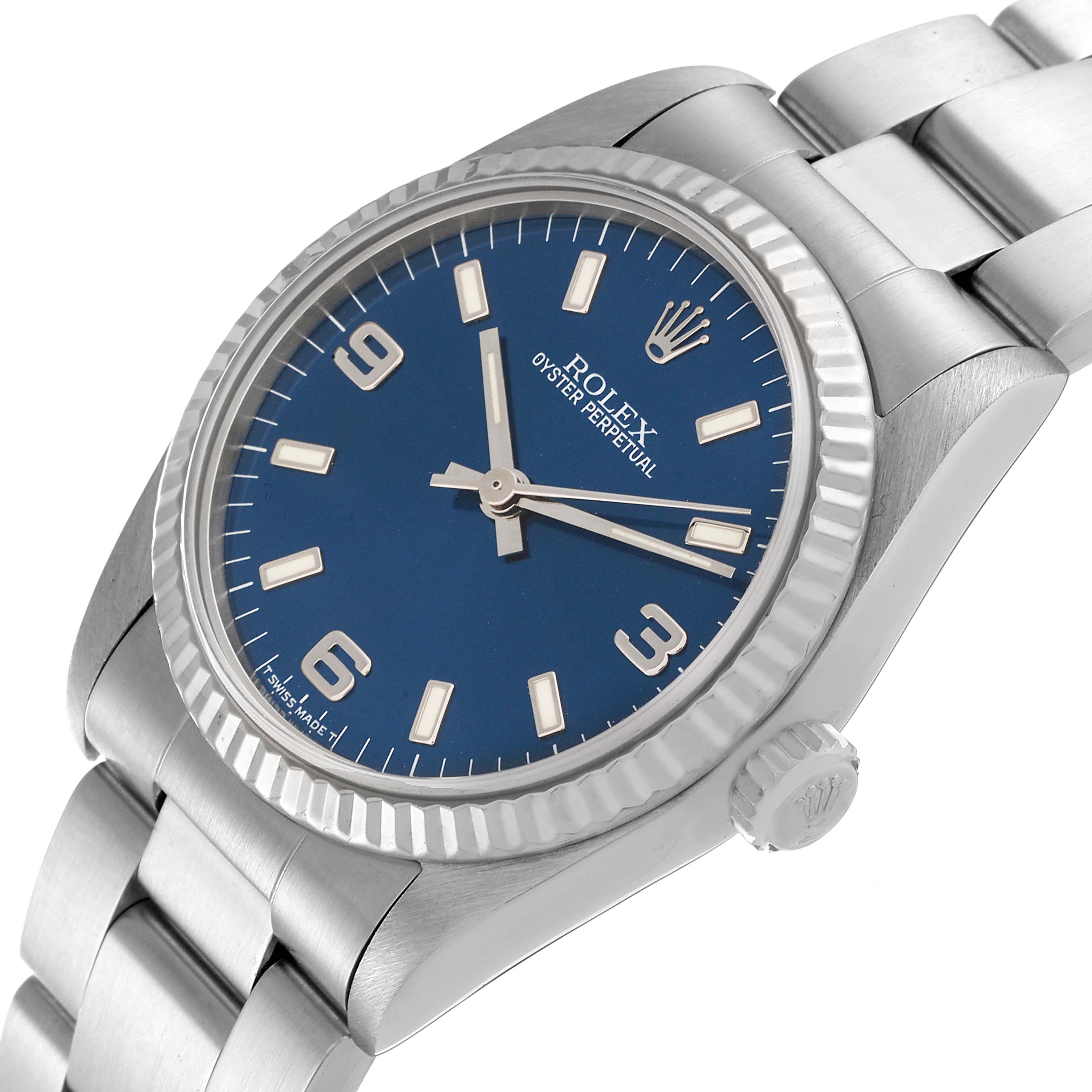 The image shows a tilted angle of a Rolex Oyster Perpetual Mid-Size watch, featuring its blue dial, crown, bezel, and part of its bracelet.