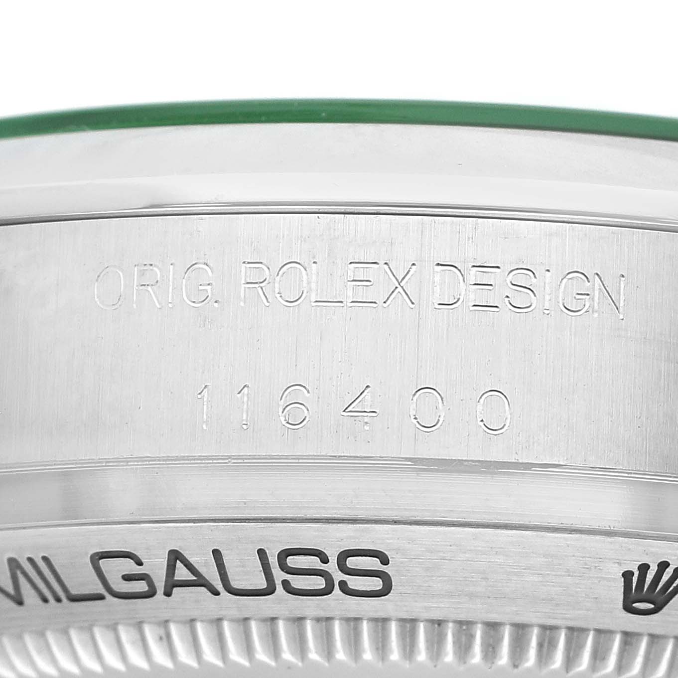 The image shows a close-up of the Milgauss model case back edge by Rolex, featuring engraved text.