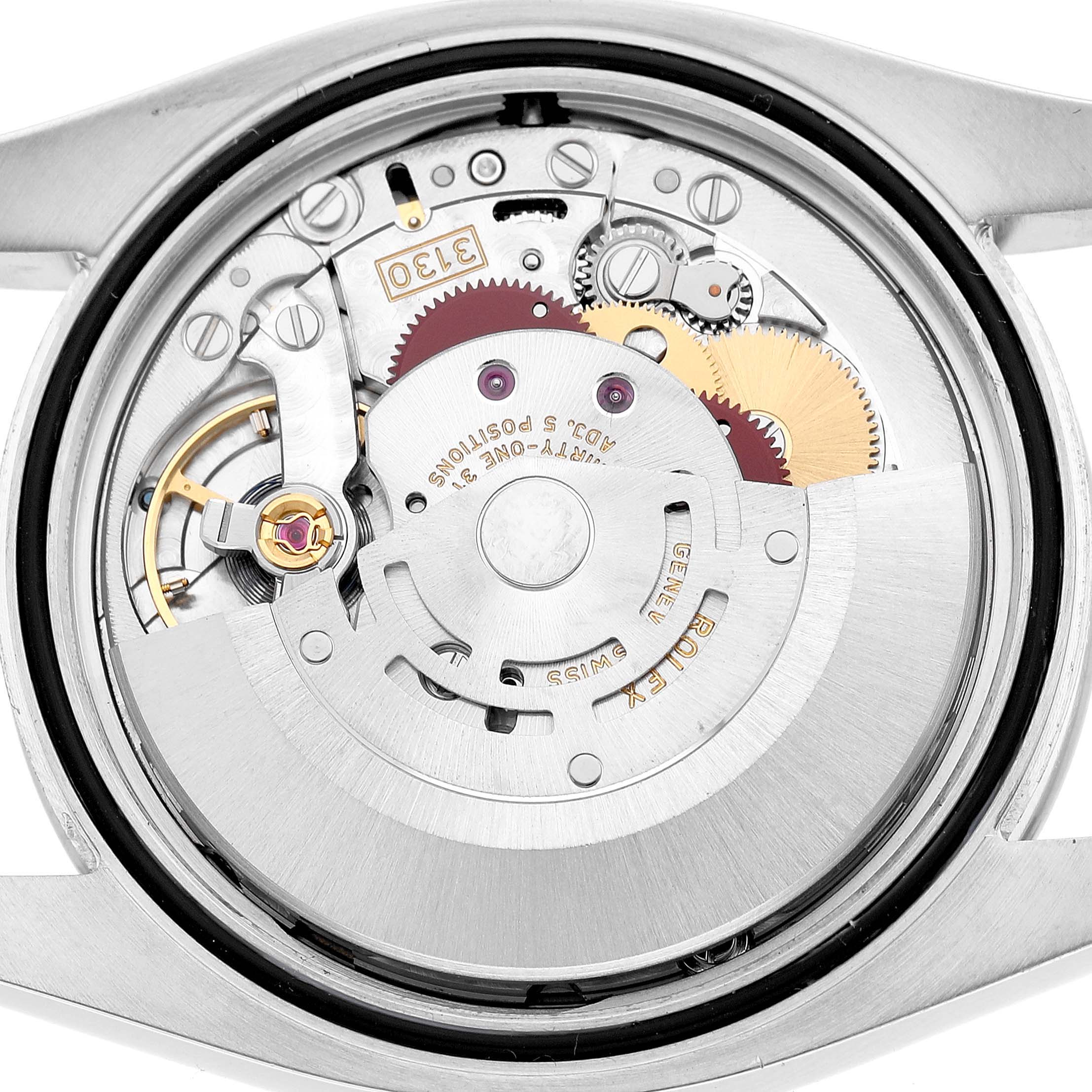 The image shows a close-up of the Rolex Oyster Perpetual 116000 Men's Stainless Steel Black Dial movement, highlighting gears and intricate details from the back.