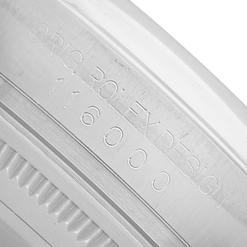 The image shows a close-up of the side engraving on the bezel of a Rolex Oyster Perpetual 116000 Men's Stainless Steel Black Dial, displaying "ORIG ROLEX DESIGN" and model number.