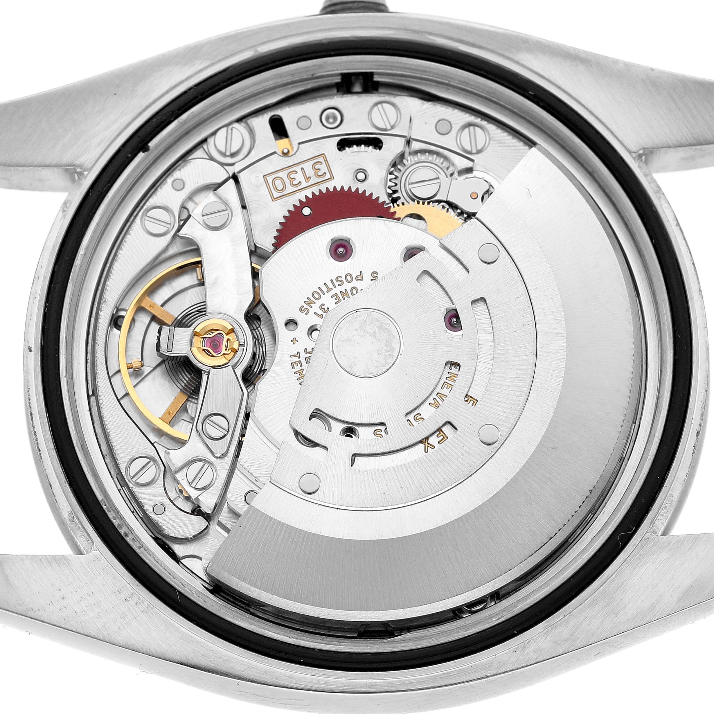 The image shows the back view of a Rolex Oyster Perpetual 116000 Men's Stainless Steel Silver Dial's mechanical movement, revealing its intricate components.