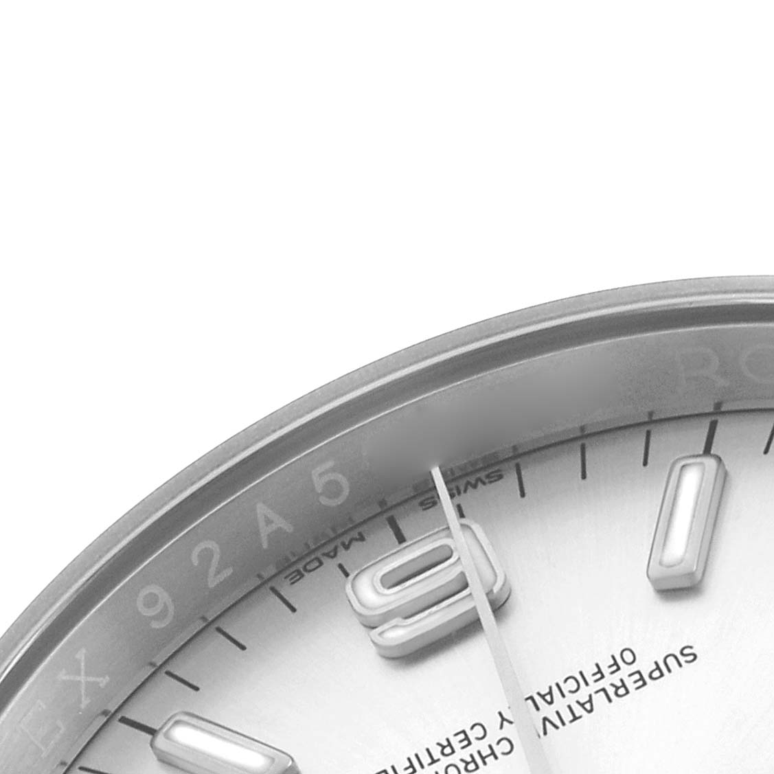 The image shows a partial close-up of the Rolex Oyster Perpetual 116000 Men's Stainless Steel Silver Dial watch, highlighting the dial, hands, hour markers, and details.