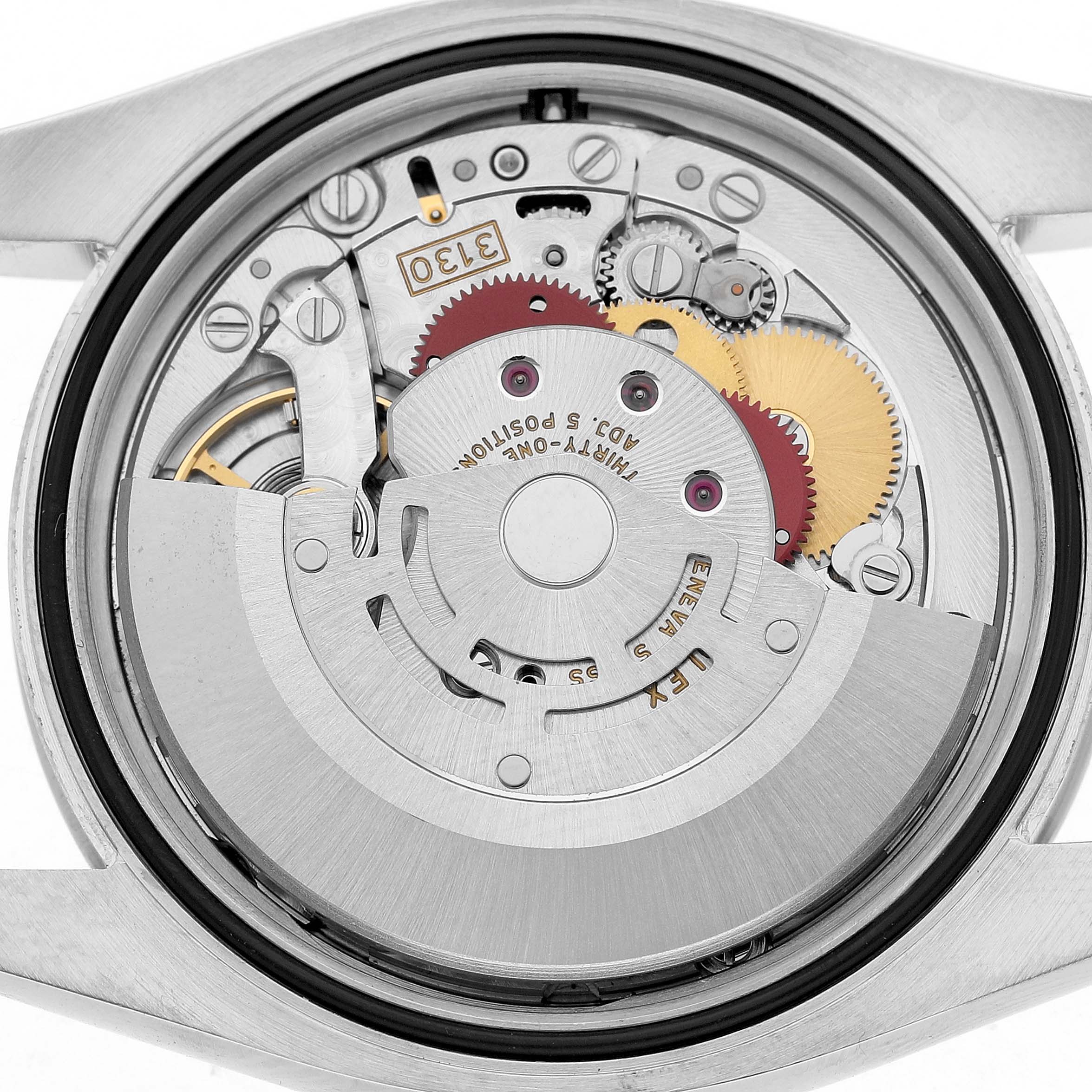 The image shows the internal mechanism of a Rolex Oyster Perpetual 116000 Men's Stainless Steel Silver Dial watch from the back, highlighting gears and the rotor.
