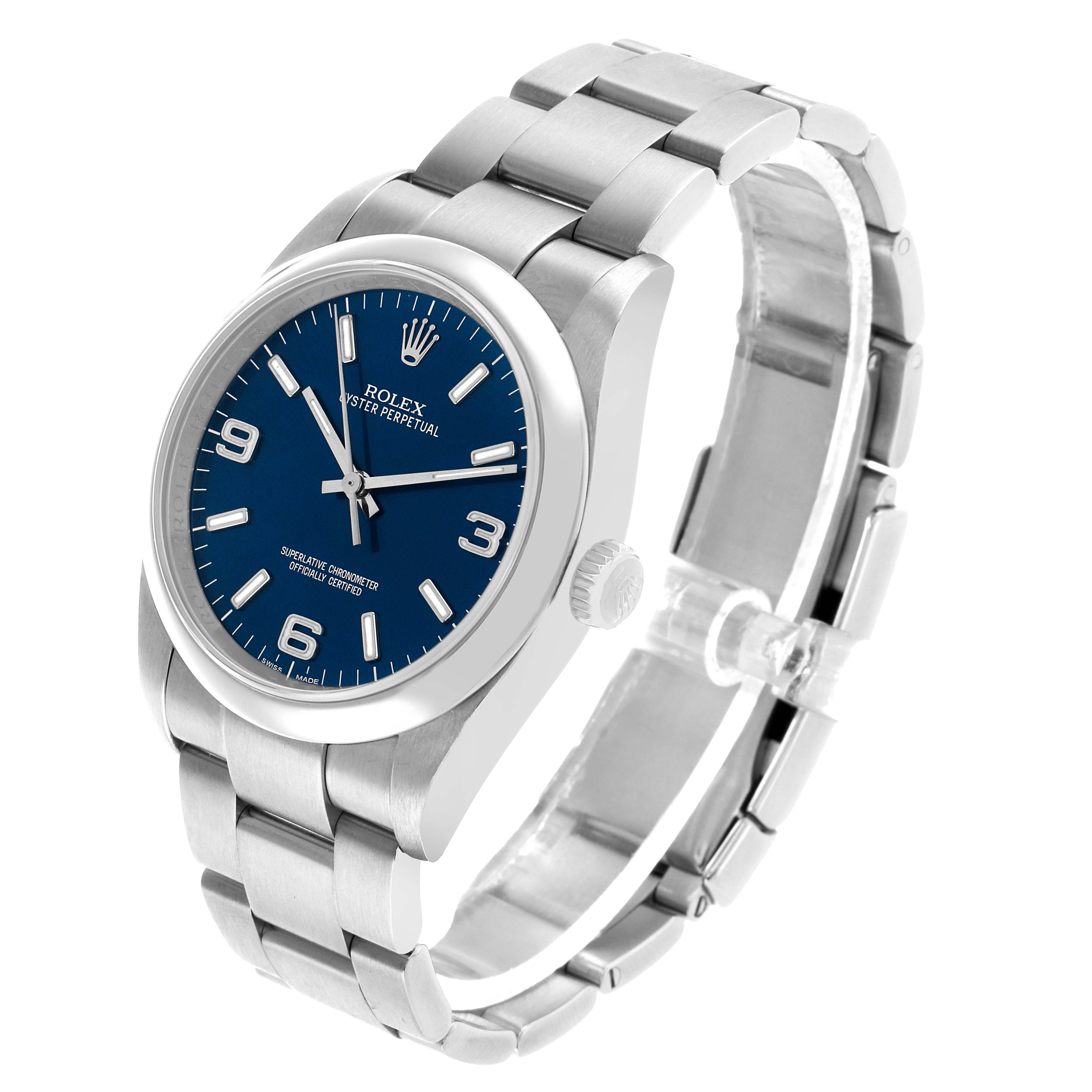 The Rolex Oyster Perpetual 116000 Men's Stainless Steel Blue Dial watch is shown at a three-quarter angle, highlighting the face, case, crown, and bracelet.