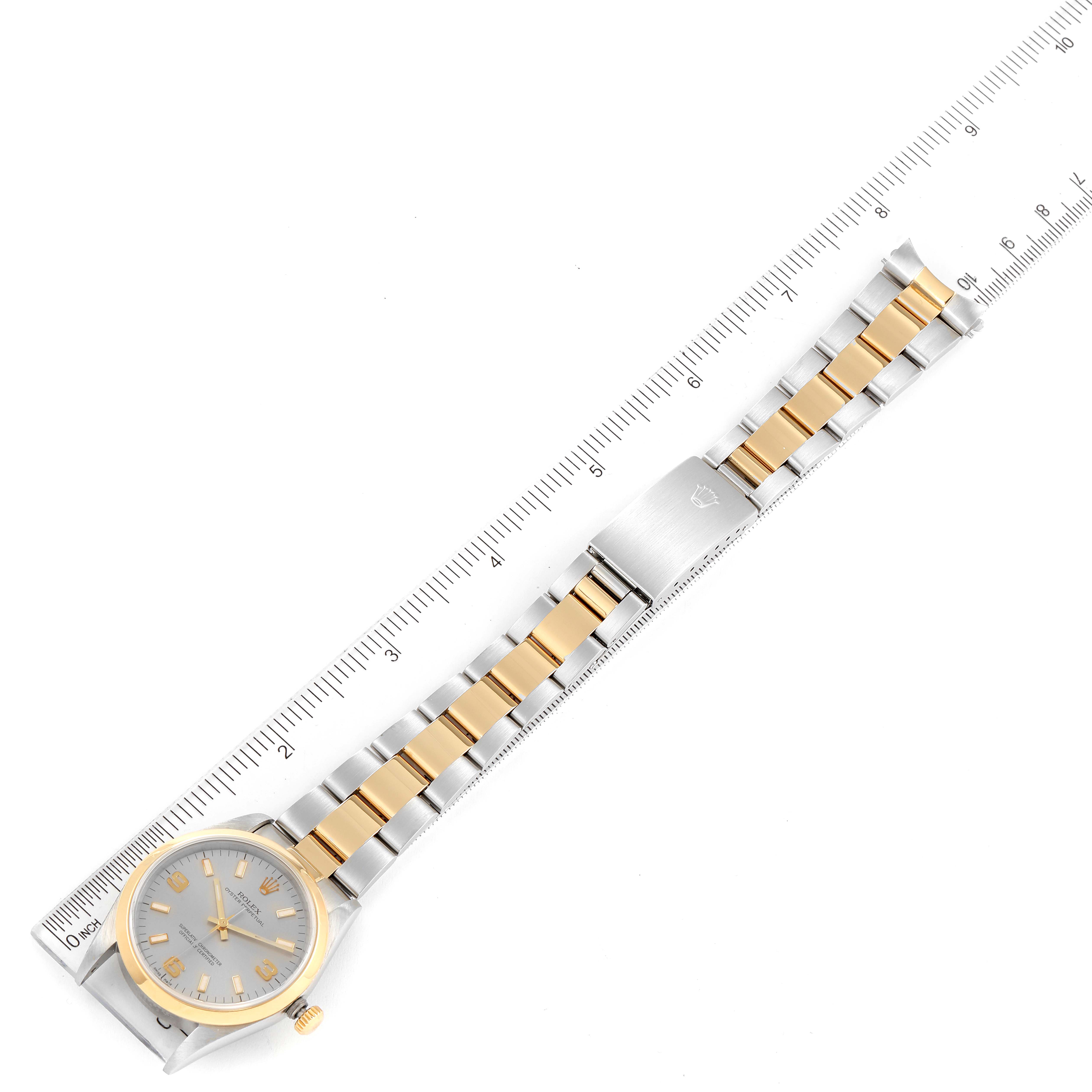 The image shows a top-down view of a Rolex Oyster Perpetual 14203 Men's Steel and Gold (two tone) Grey Dial 14203 Men's Steel and Gold (two tone) Grey Dial watch, displaying its face, bezel, and two-tone metal bracelet alongside a ruler for scale.