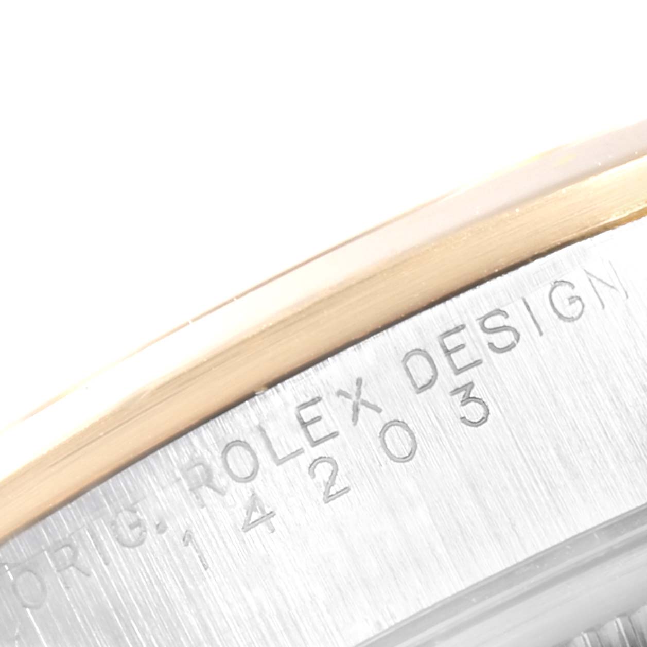 The image shows a close-up of the edge of a Rolex Oyster Perpetual 14203 Men's Steel and Gold (two tone) Grey Dial 14203 Men's Steel and Gold (two tone) Grey Dial watch case with engravings visible.