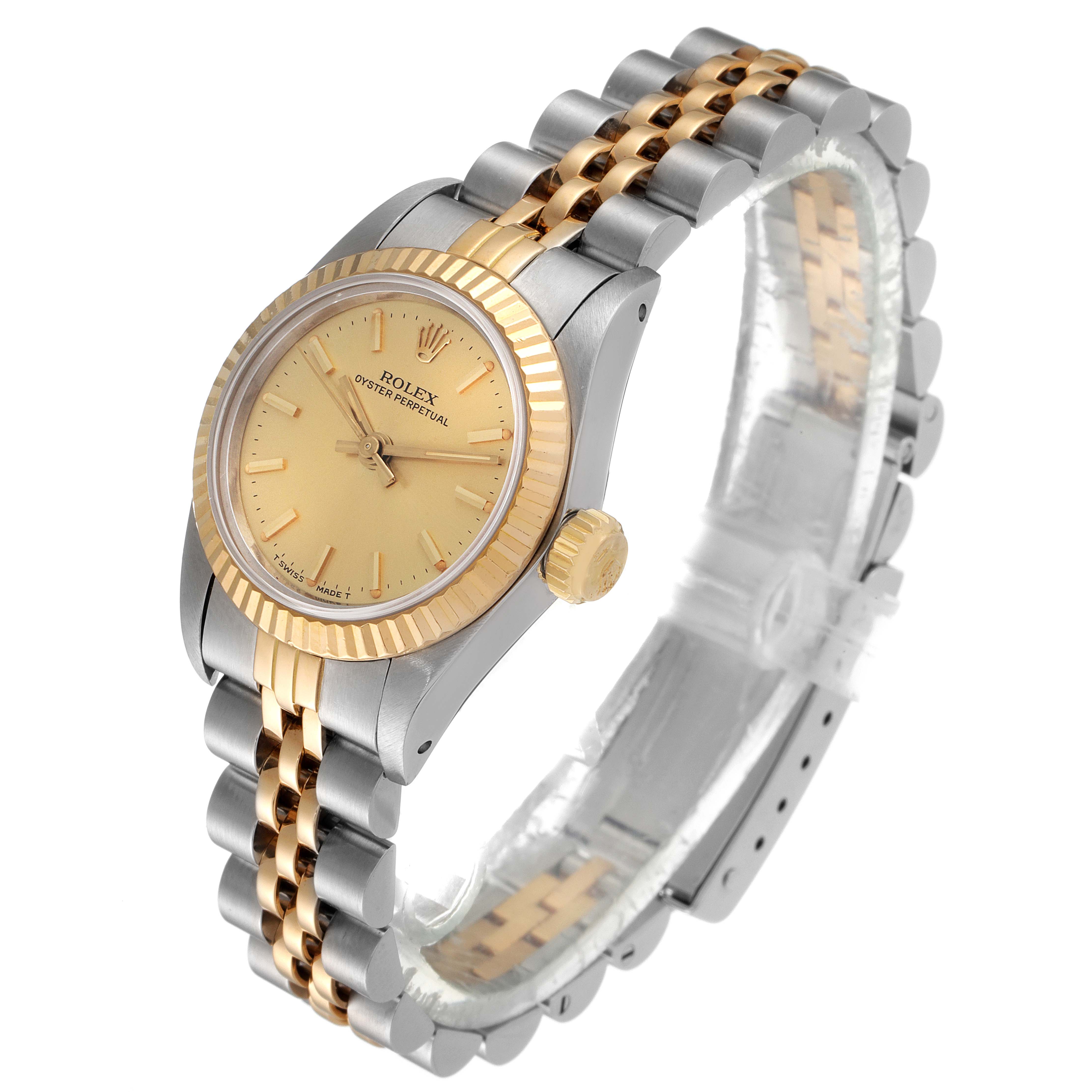 The image shows an angled view of the Rolex Oyster Perpetual 67193 Women's Steel and Gold (two tone) Champagne Dial 67193 Women's Steel and Gold (two tone) Champagne Dial watch, highlighting the dial, bezel, and two-tone bracelet.