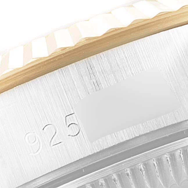 This close-up shows a portion of the bezel and case with model number engraving of a Rolex Oyster Perpetual 67193 Women's Steel and Gold (two tone) Champagne Dial 67193 Women's Steel and Gold (two tone) Champagne Dial watch.