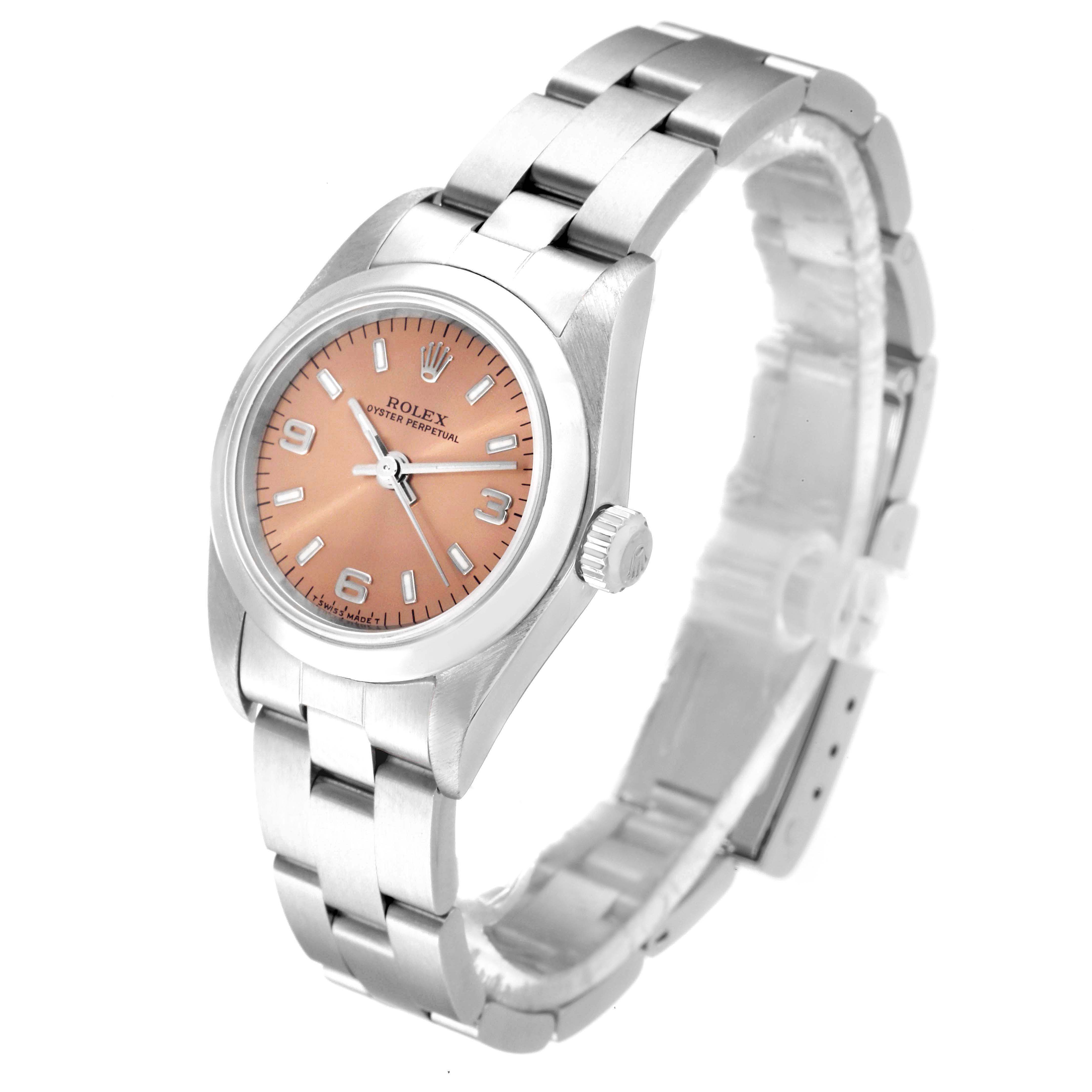 The Rolex Oyster Perpetual 76080 Women
s Stainless Steel Pink Dial 76080 Women
s Stainless Steel Pink Dial watch is shown at a three-quarter angle, displaying its face, bezel, and bracelet.