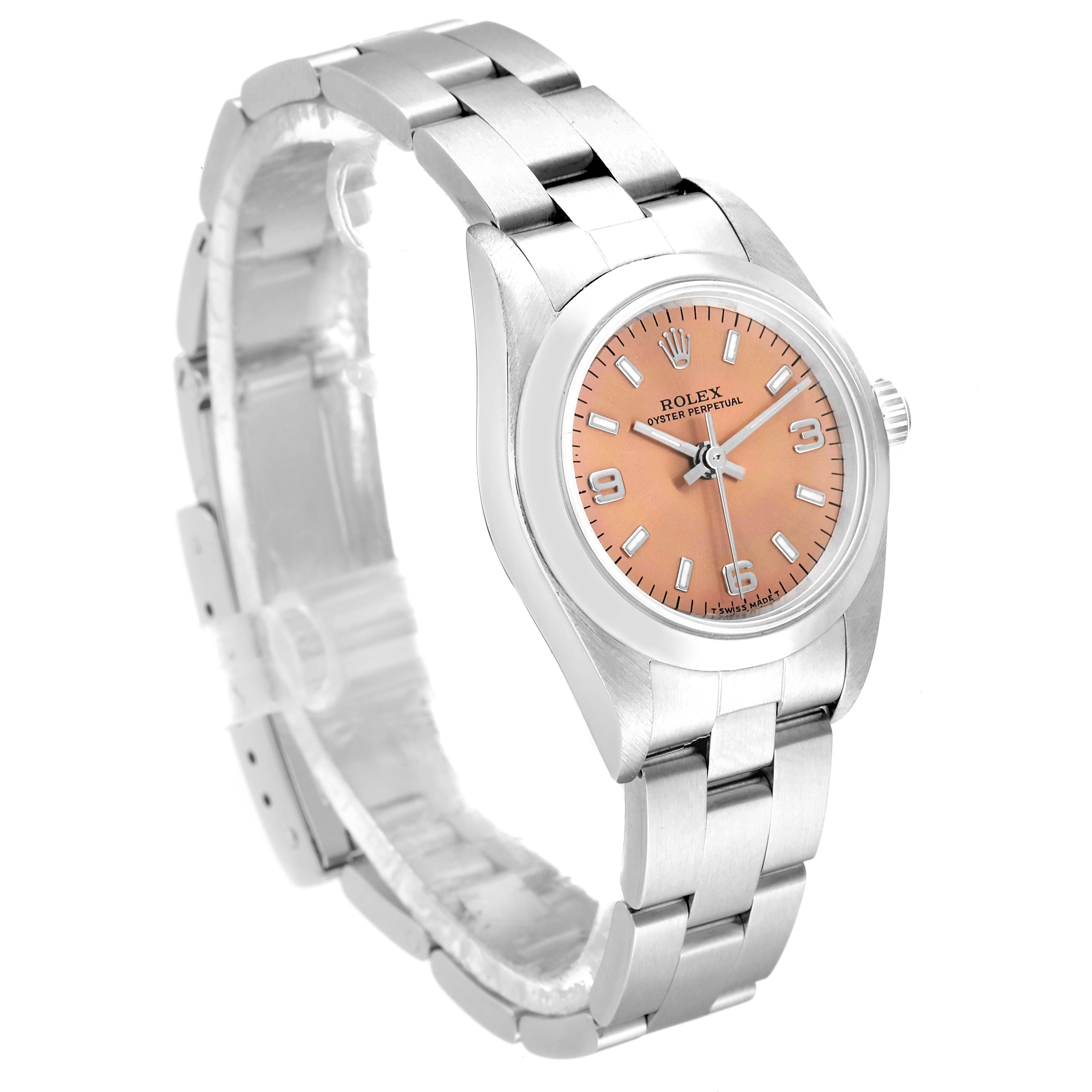 The Rolex Oyster Perpetual 76080 Women
s Stainless Steel Pink Dial 76080 Women
s Stainless Steel Pink Dial watch is shown at a slight angle, displaying its silver bracelet and salmon-colored dial.