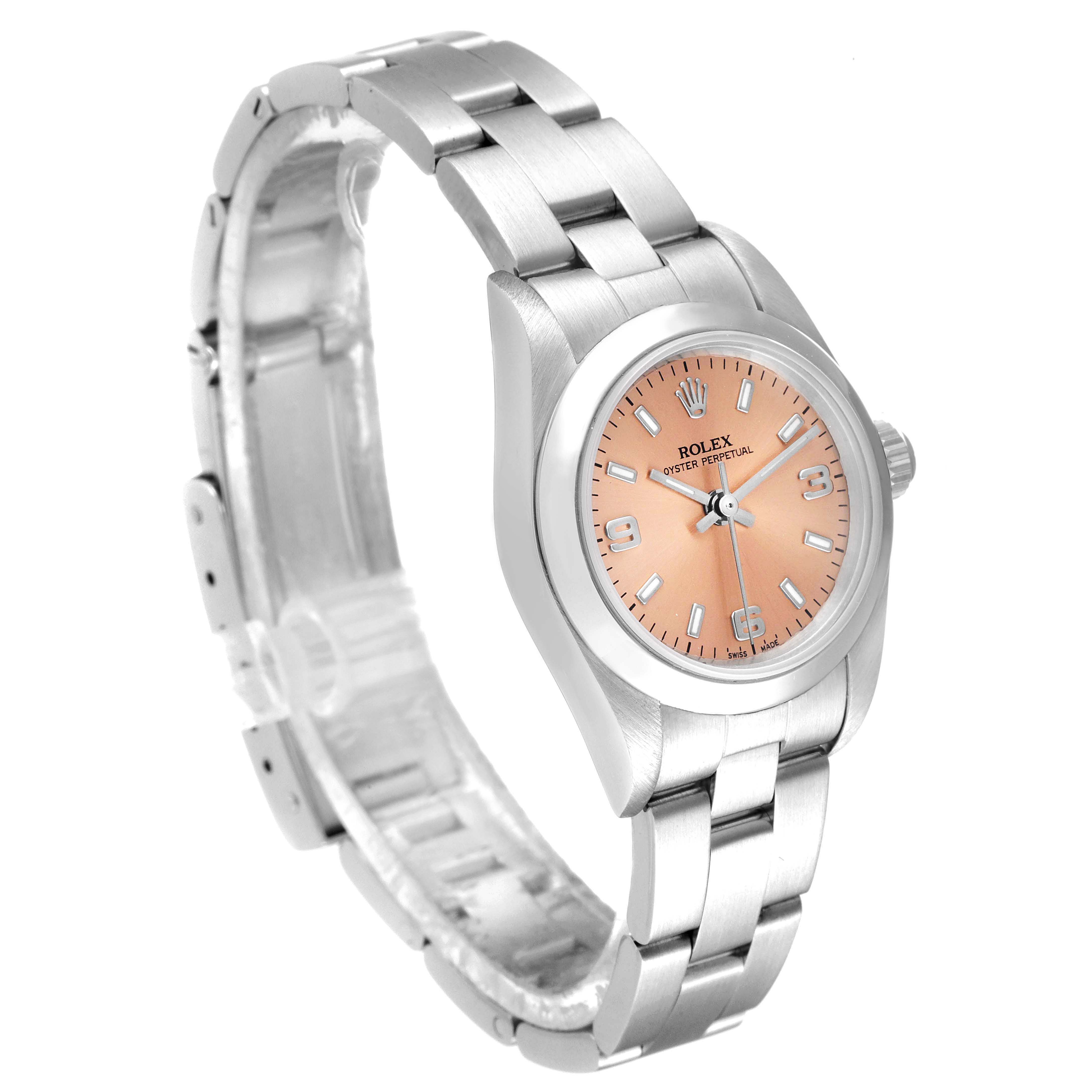 The Rolex Oyster Perpetual 76080 Women's Stainless Steel Pink Dial 76080 Women's Stainless Steel Pink Dial watch is shown at a side angle, highlighting its bracelet, case, and salmon dial.