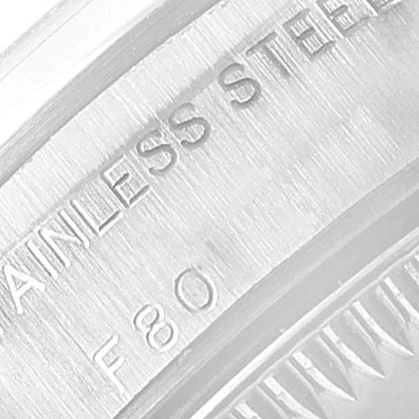 This image shows a close-up of the engraved stainless steel case back of a Rolex Oyster Perpetual 76080 Women's Stainless Steel Pink Dial 76080 Women's Stainless Steel Pink Dial watch.
