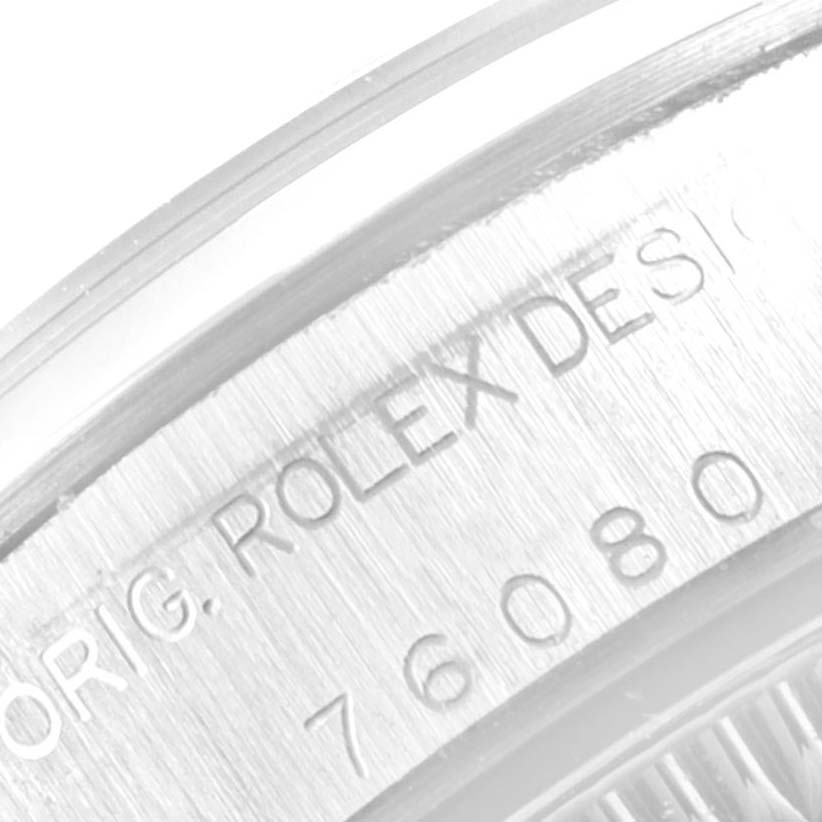 This image shows a close-up view of the serial engraving on the case of a Rolex Oyster Perpetual 76080 Women's Stainless Steel Pink Dial 76080 Women's Stainless Steel Pink Dial watch.