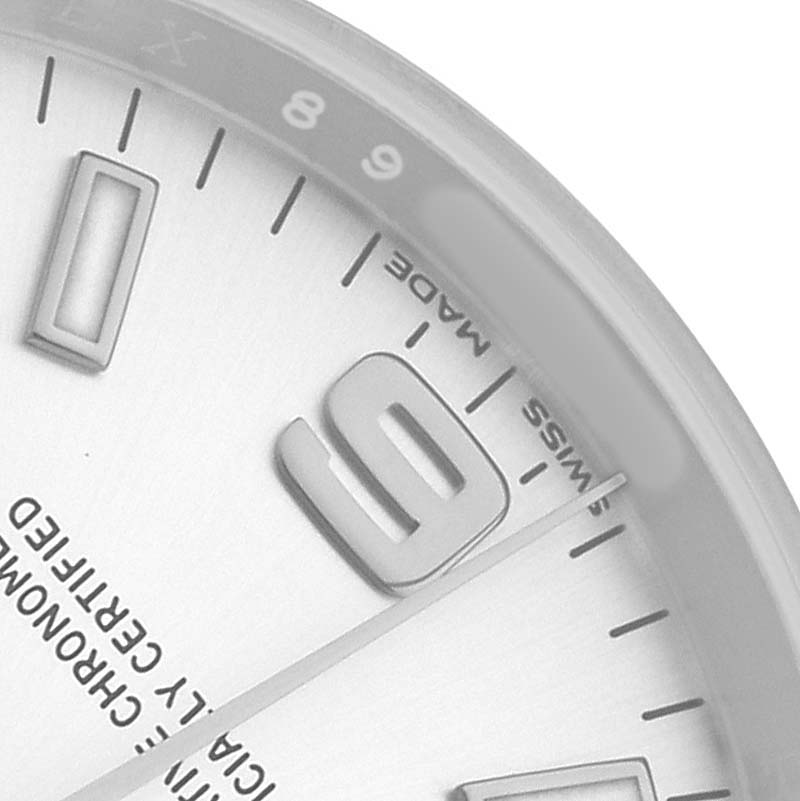The image shows a close-up of the dial of a Rolex Oyster Perpetual 114200 Men's Stainless Steel Silver Dial, focusing on the 3 o'clock to 9 o'clock area.