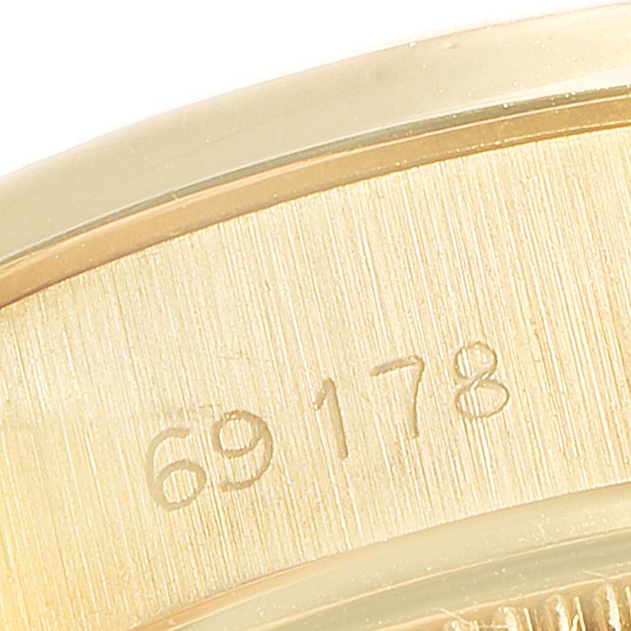 The image shows a close-up of the case back and serial number of a Rolex President 69178 Women's Yellow Gold Champagne Dial 69178 Women's Yellow Gold Champagne Dial model watch.