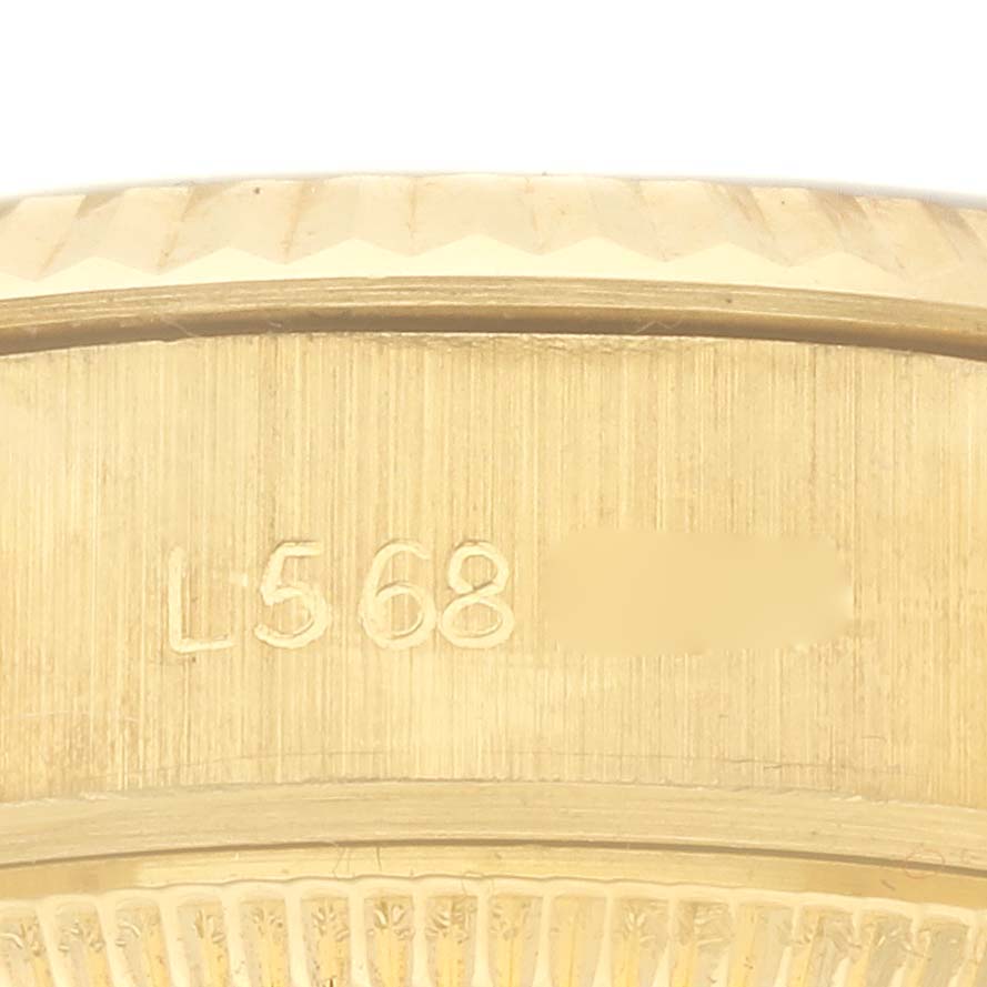 The image shows a close-up of the case side with engravings on a Rolex President 69178 Women's Yellow Gold Champagne Dial 69178 Women's Yellow Gold Champagne Dial model watch.