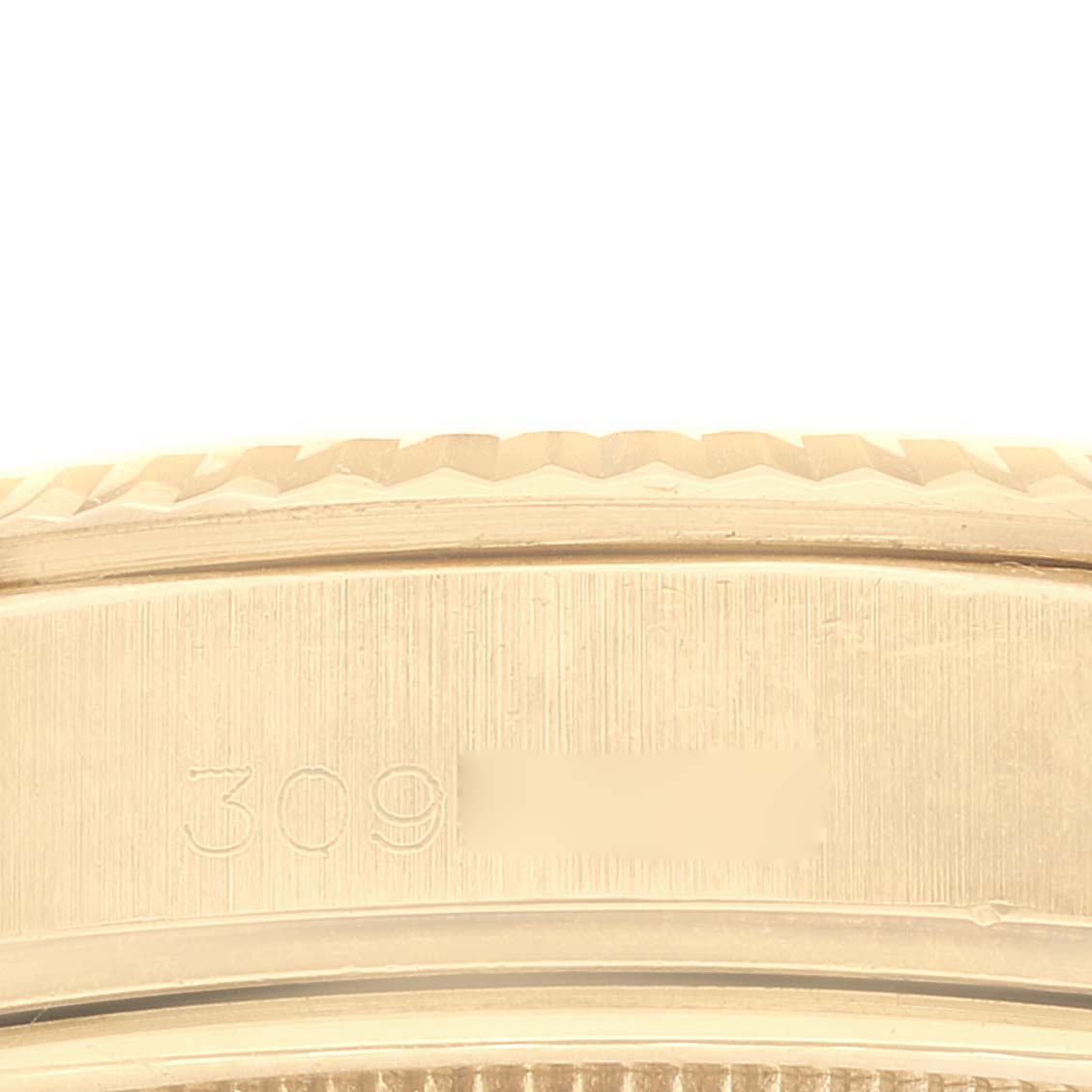 This close-up image shows the engraved serial number on the side of the Rolex President 1803 Men's Yellow Gold Champagne Dial 1803 Men's Yellow Gold Champagne Dial watch case.