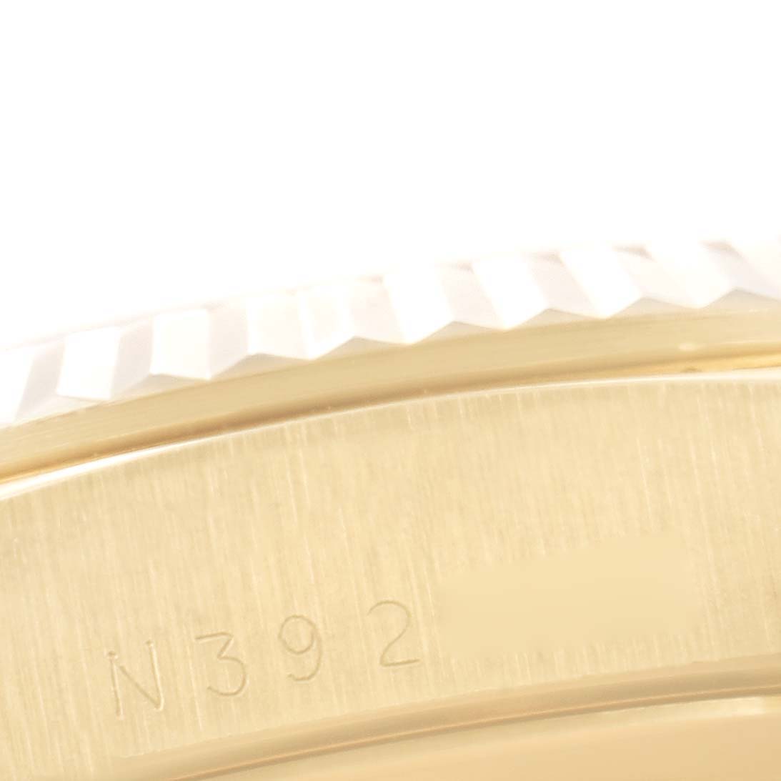 The image shows a close-up of the case and bezel of a Rolex President 18238 Men's Yellow Gold Champagne Dial 18238 Men's Yellow Gold Champagne Dial watch, highlighting part of the serial number.