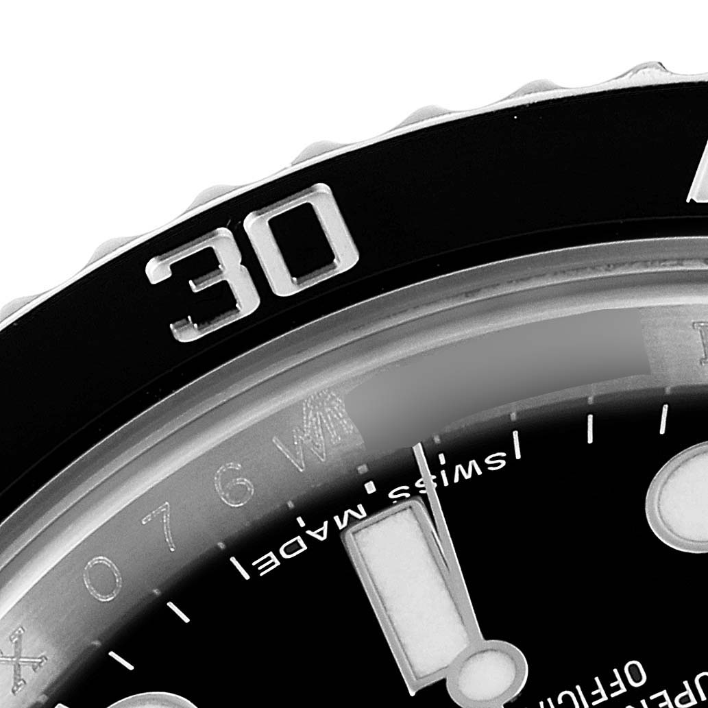 This close-up image of the Rolex Submariner 114060 Men's Stainless Steel Black Dial 114060 Men's Stainless Steel Black Dial watch shows the edge of the bezel, the dials, and part of the minute markers.