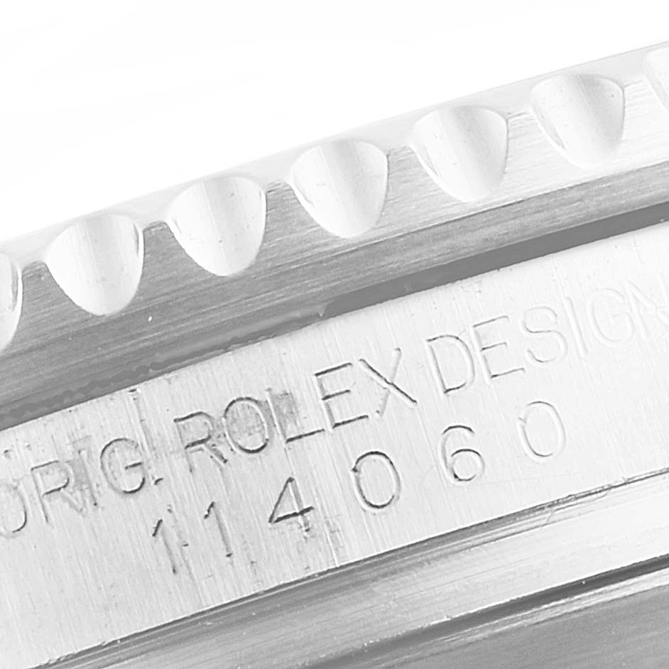 This close-up photo shows the engraved bezel and case edge of the Rolex Submariner 114060 Men's Stainless Steel Black Dial 114060 Men's Stainless Steel Black Dial watch.