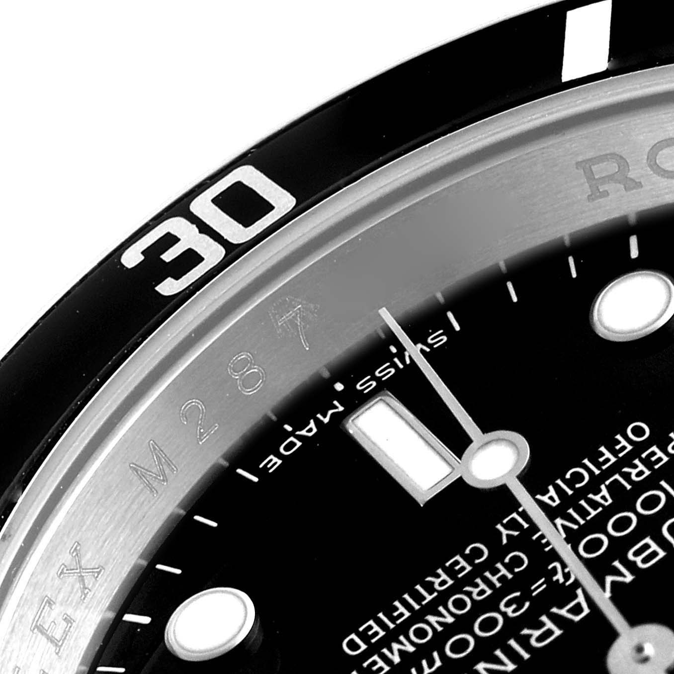 Close-up angle of the Rolex Submariner 16610 Men's Stainless Steel Black Dial 16610 Men's Stainless Steel Black Dial watch face, showing part of the bezel, hour markers, and text on the dial.