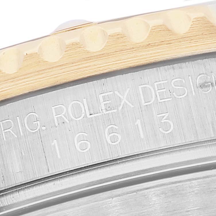 The image shows a close-up of the model number engraving "16613" and part of the rotating bezel of a Rolex Submariner 16613 Men's Steel and Gold (two tone) Blue Dial 16613 Men's Steel and Gold (two tone) Blue Dial watch.