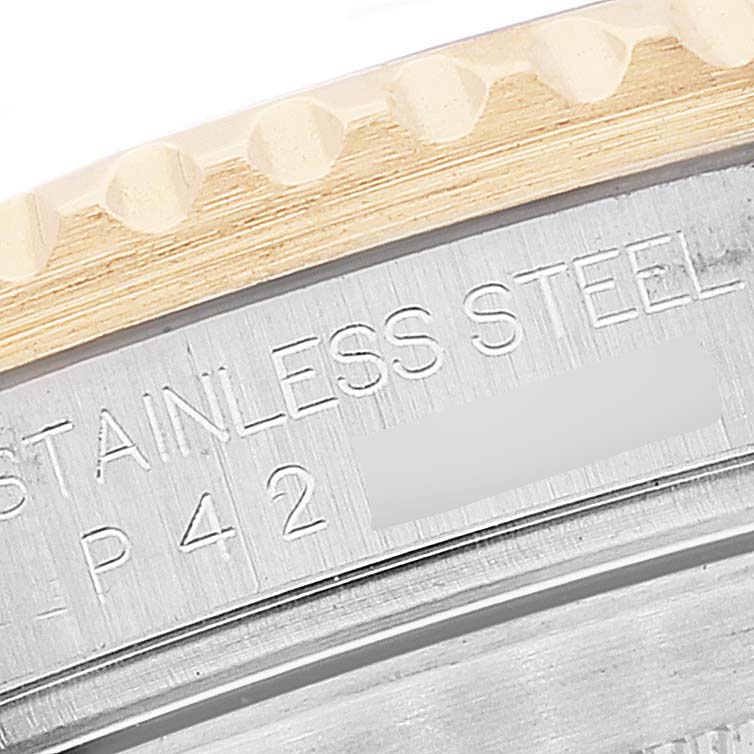 The image shows a close-up of the bezel and part of the case back of a Rolex Submariner 16613 Men's Steel and Gold (two tone) Blue Dial 16613 Men's Steel and Gold (two tone) Blue Dial watch, featuring the text "STAINLESS STEEL."