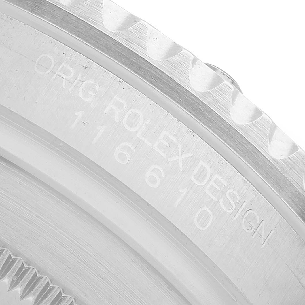 The image shows a close-up of the side of a Rolex Submariner 116610LV Men's Stainless Steel Green Dial watch, focusing on the engraved model number and design details.