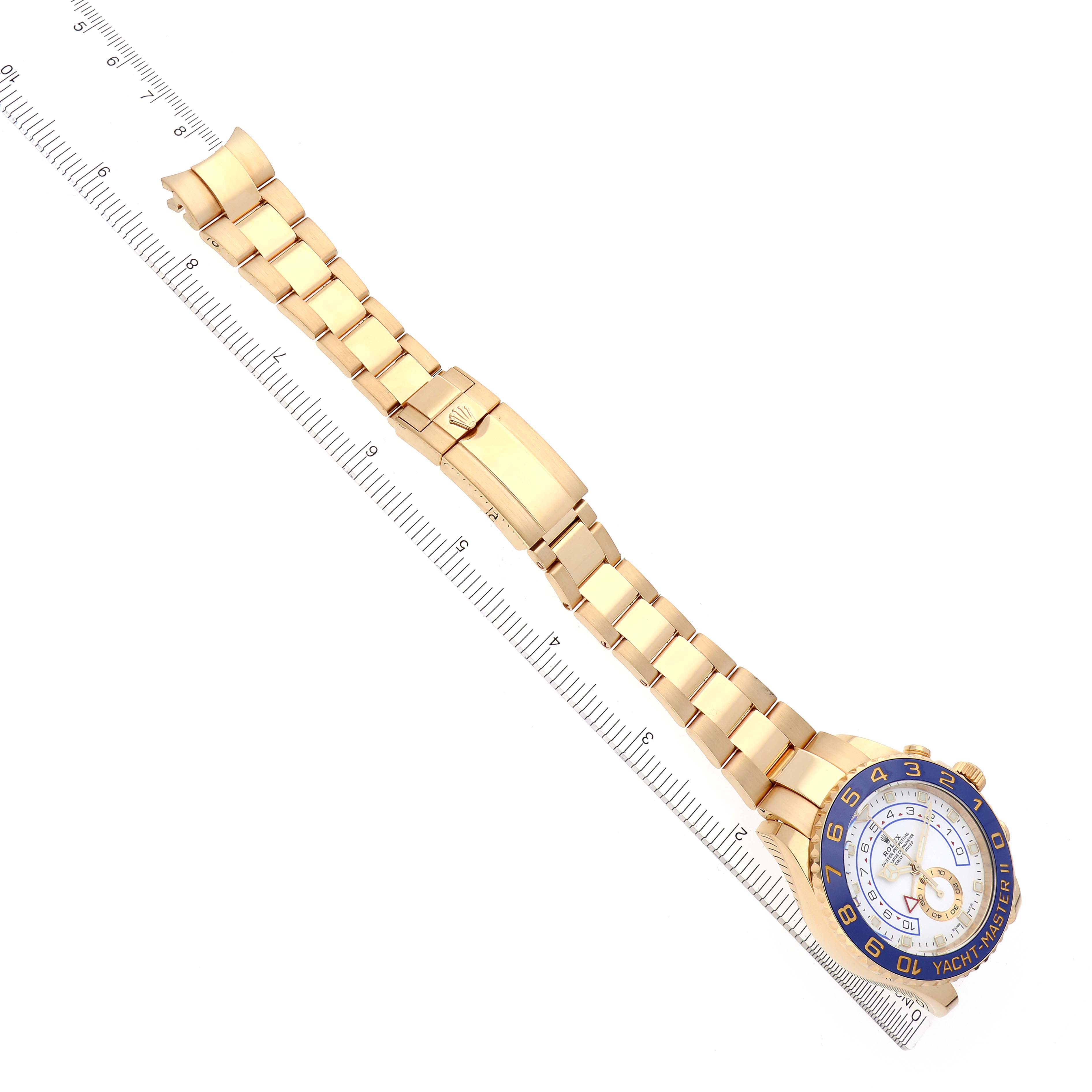 The Rolex Yacht-Master 116688 Men's Yellow Gold White Dial 116688 Men's Yellow Gold White Dial watch is shown from a top view, displaying the full bracelet and face alongside a ruler for scale.