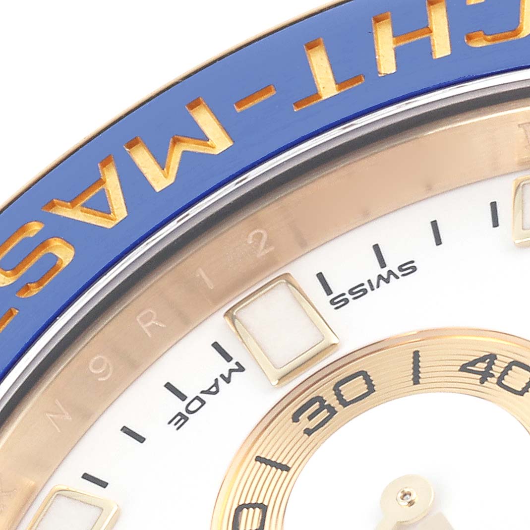 The image shows a close-up of the Rolex Yacht-Master 116688 Men's Yellow Gold White Dial 116688 Men's Yellow Gold White Dial bezel and part of the dial with indices.