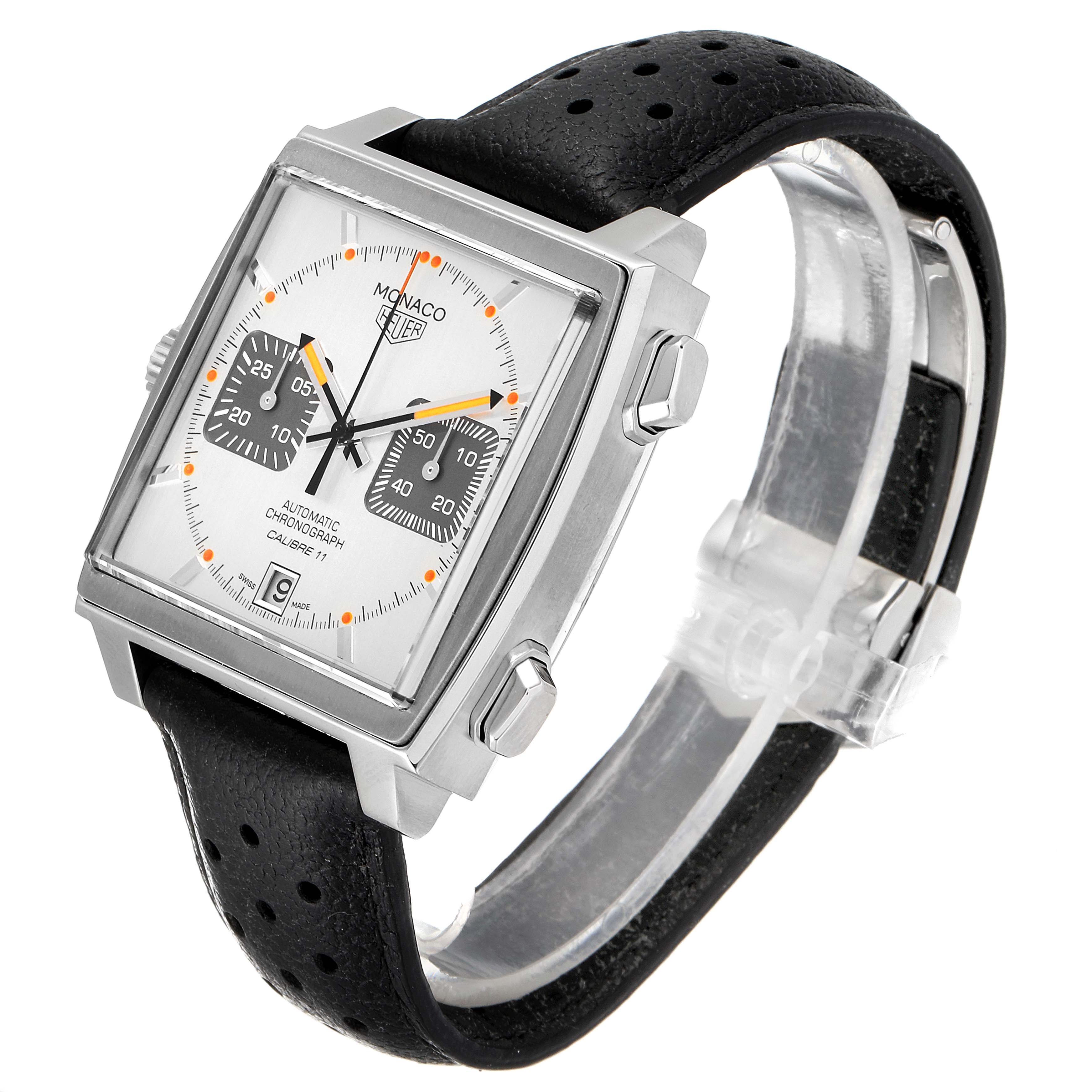 The image shows a Tag Heuer Monaco watch at a slight angle, highlighting its square dial, chronograph features, and black leather strap.