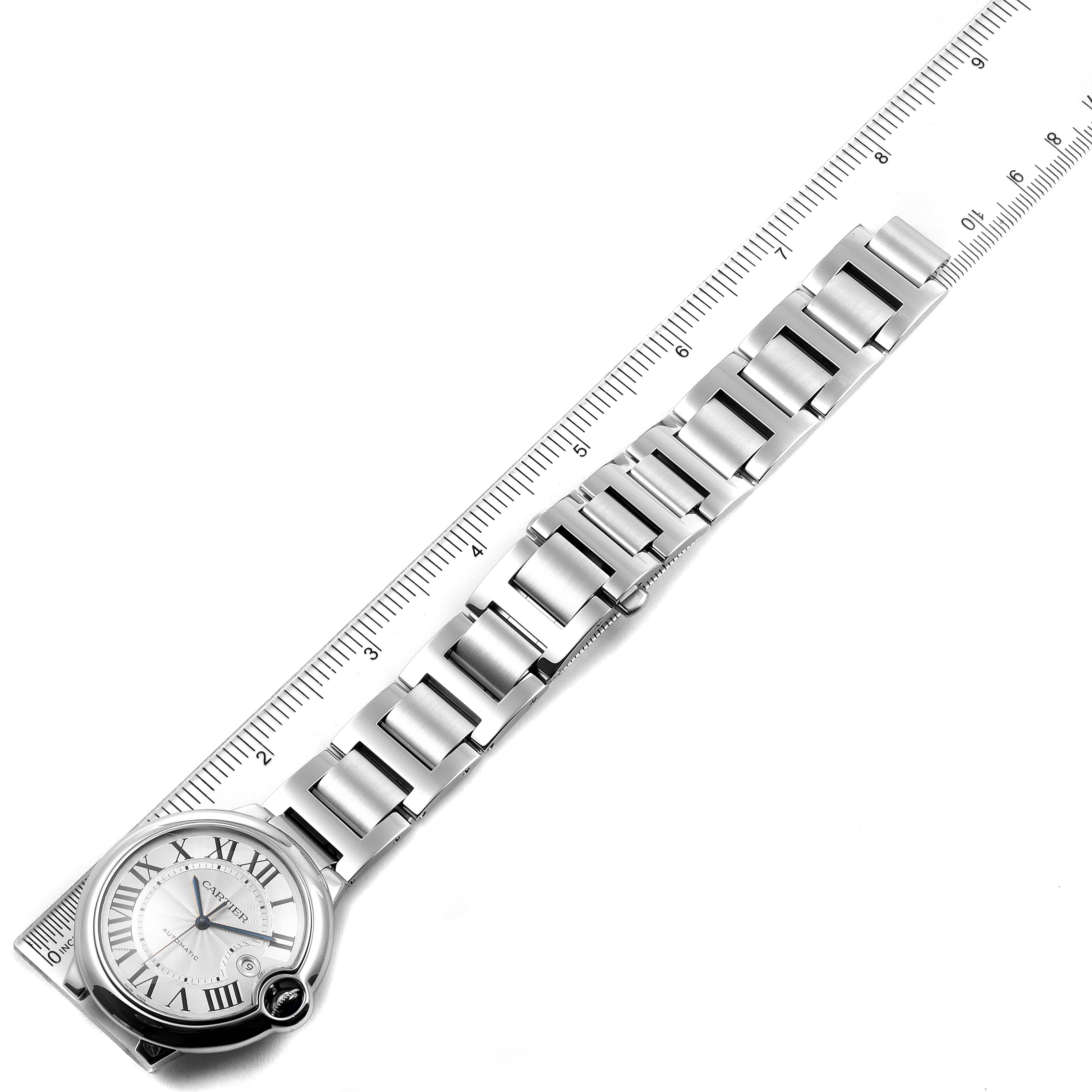 The image shows the Cartier Ballon Bleu W69012Z4 Men's Stainless Steel Silver Dial W69012Z4 Men's Stainless Steel Silver Dial watch and its metal bracelet, laid flat against a ruler for length measurement.