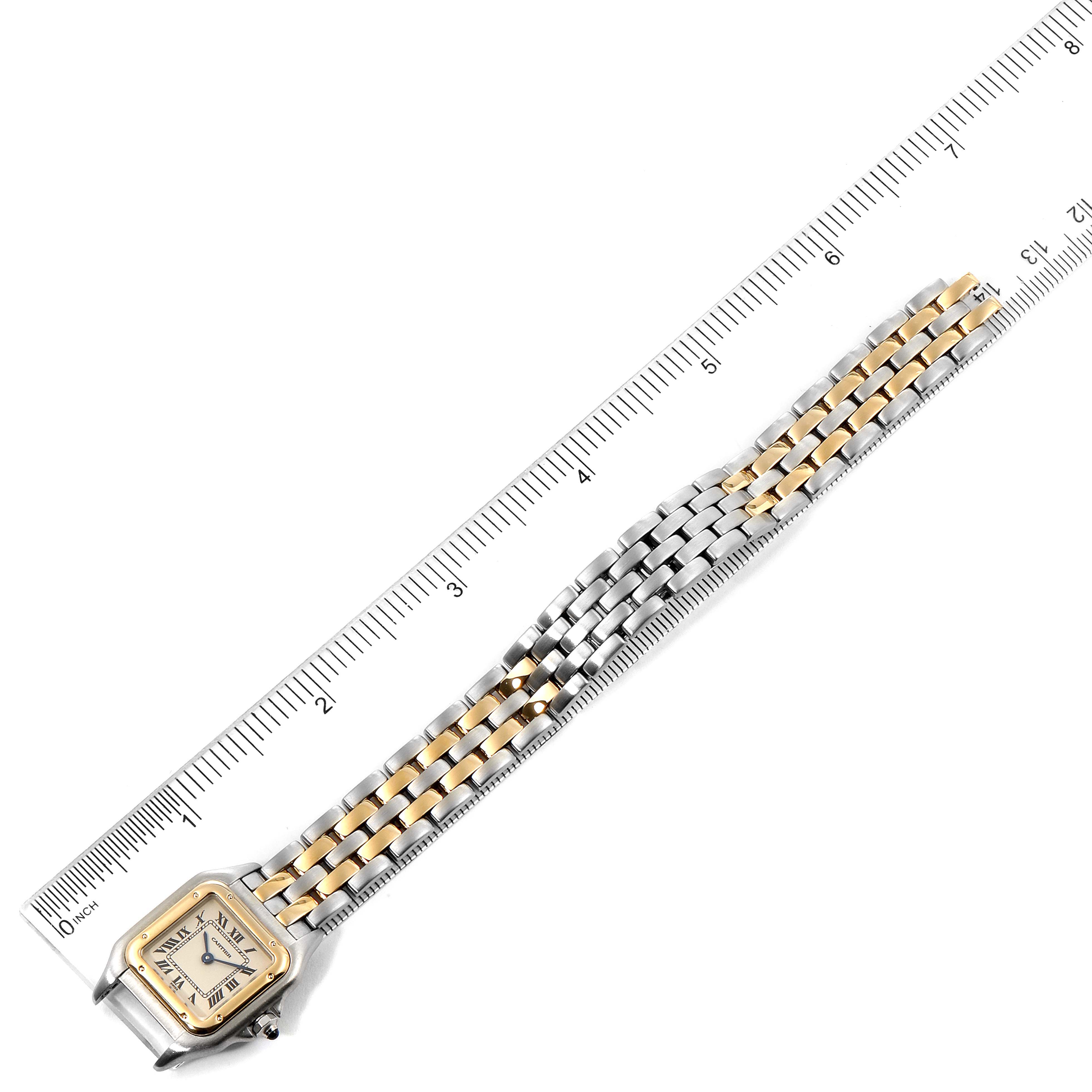 The image shows a Panthère de Cartier watch from an overhead angle, highlighting its two-tone metal bracelet and square face alongside a ruler.